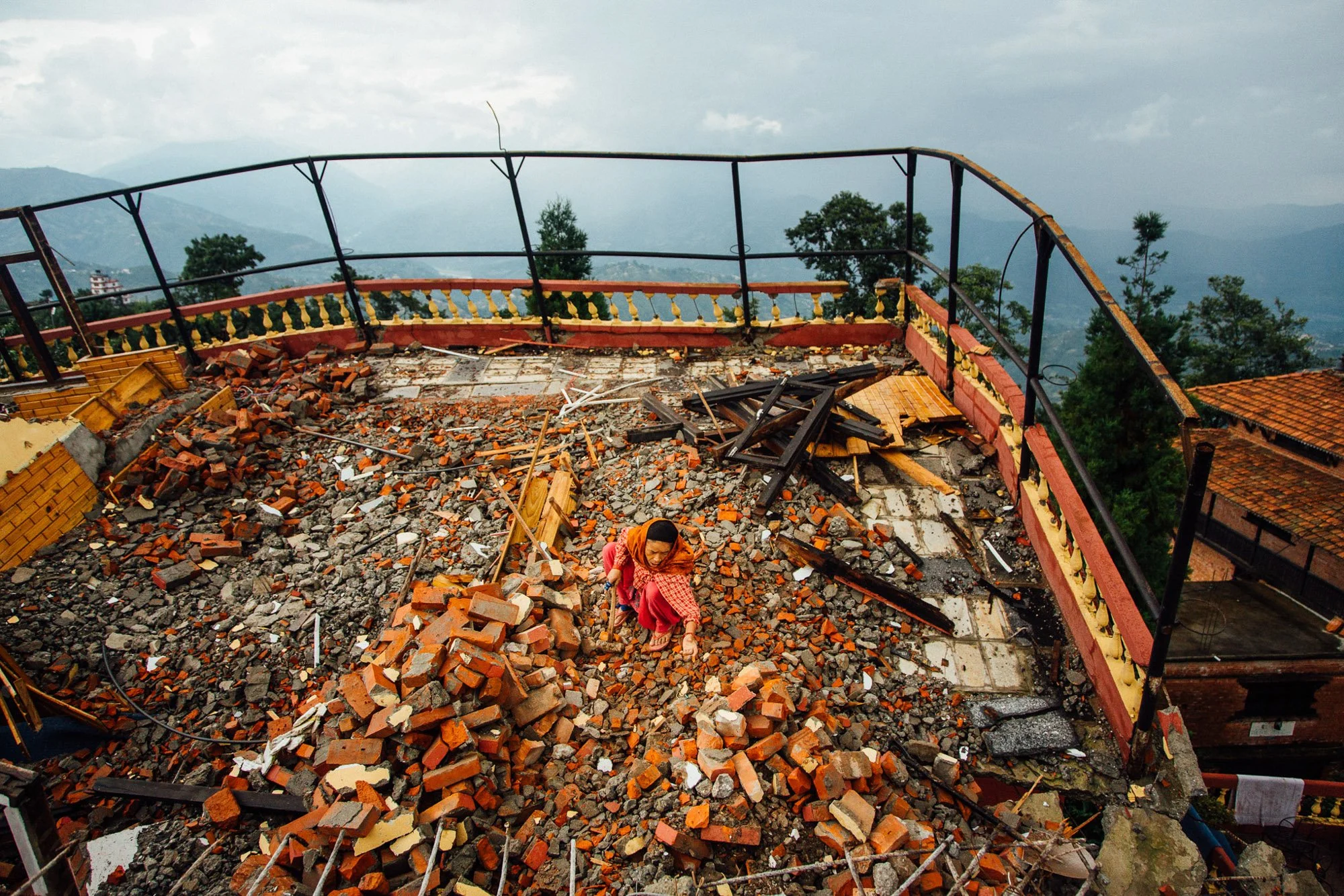 Labourers clear debris and rubble on the top floor of what was once a hotel which was destroyed by the Nepal earthquake in the Nagarkot hill station village anciently known as Mandapgiri in the Bhaktapur District, Nepal.