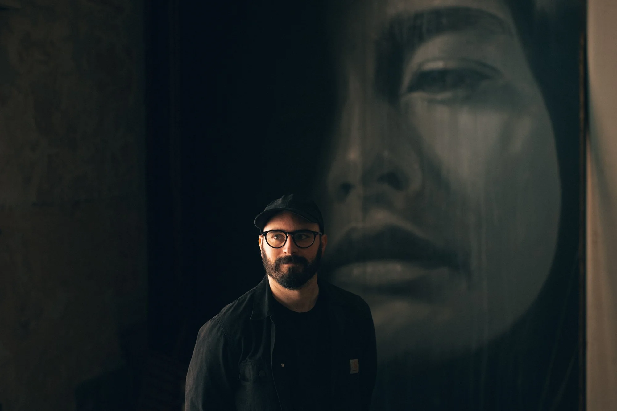 Portrait of artist RONE inside Flinders Street Station during a media preview of his immersive installation Time in Melbourne.