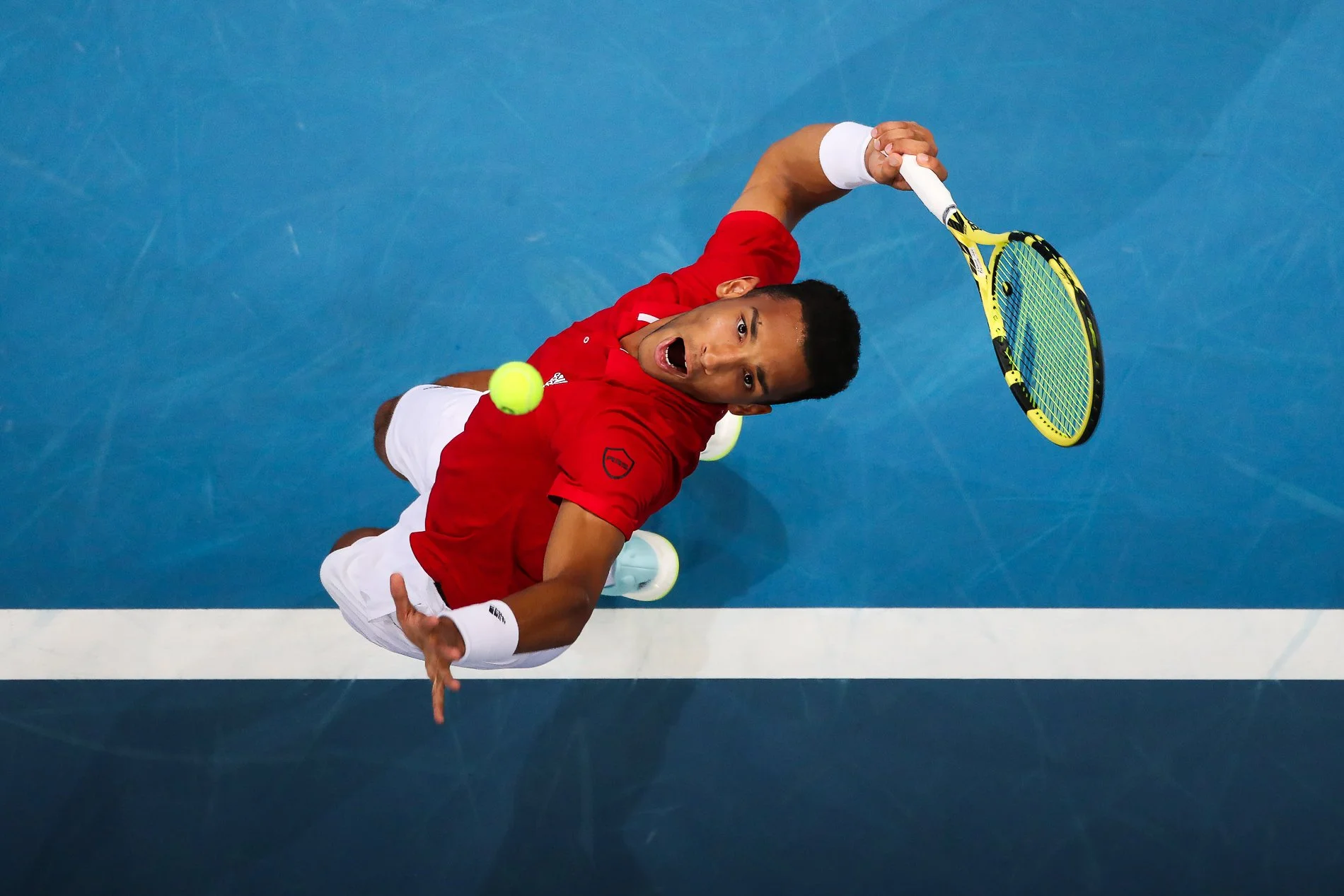 Felix Auger Aliassime serves during his ATP Cup group stage match against Alexander Zverev at Sydney Olympic Park in 2022.