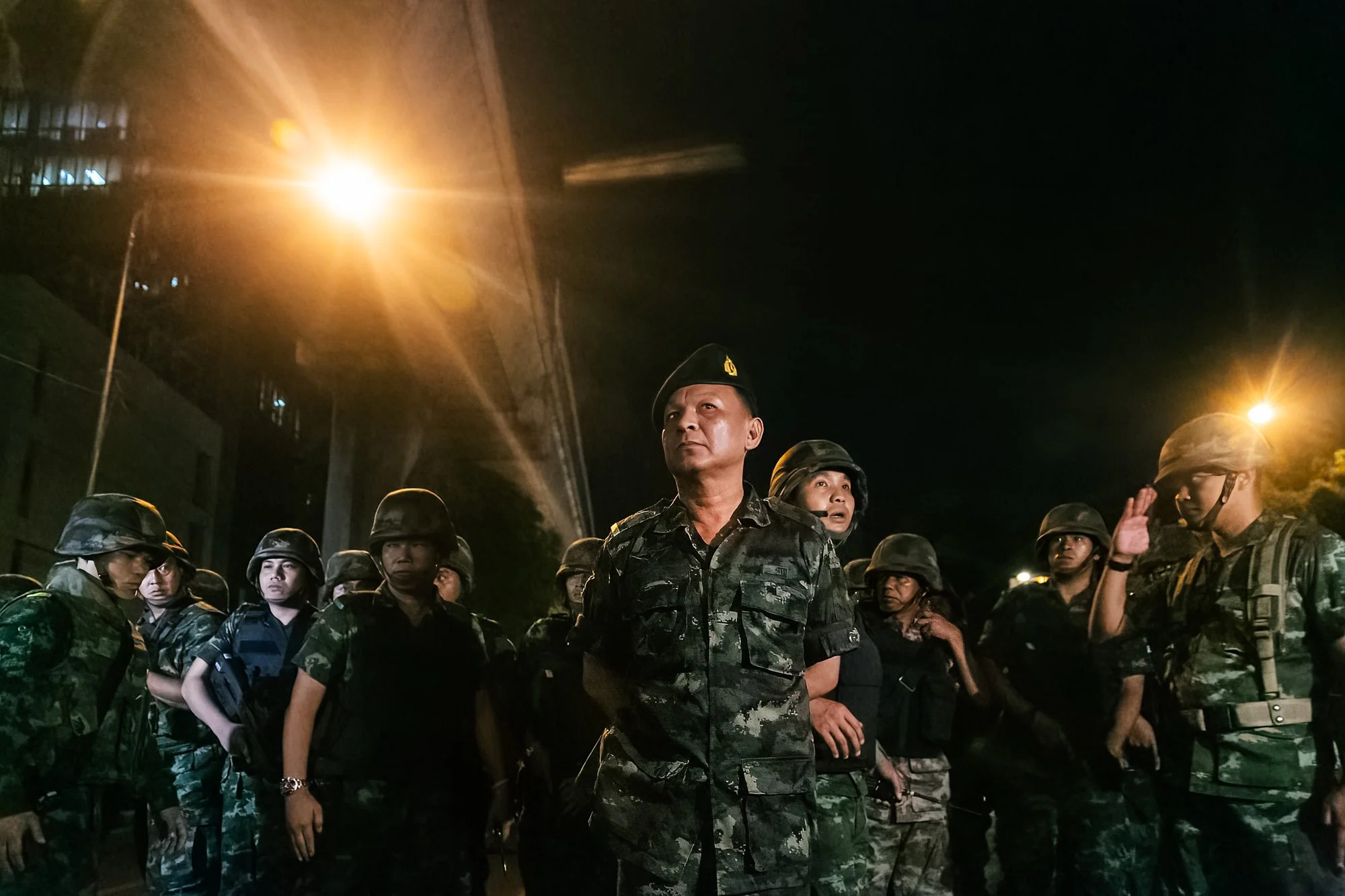 A senior Army officer looks out towards protestors following a Anti-Coup protest in Bangkok