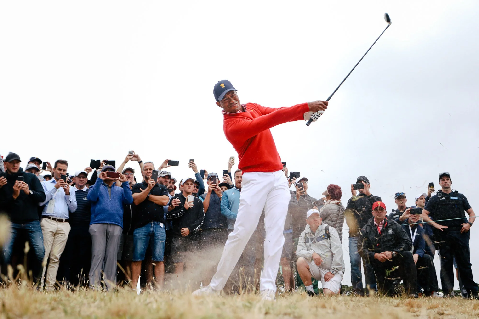 Tiger Woods plays out of the rough on the 1st hole during the Presidents Cup