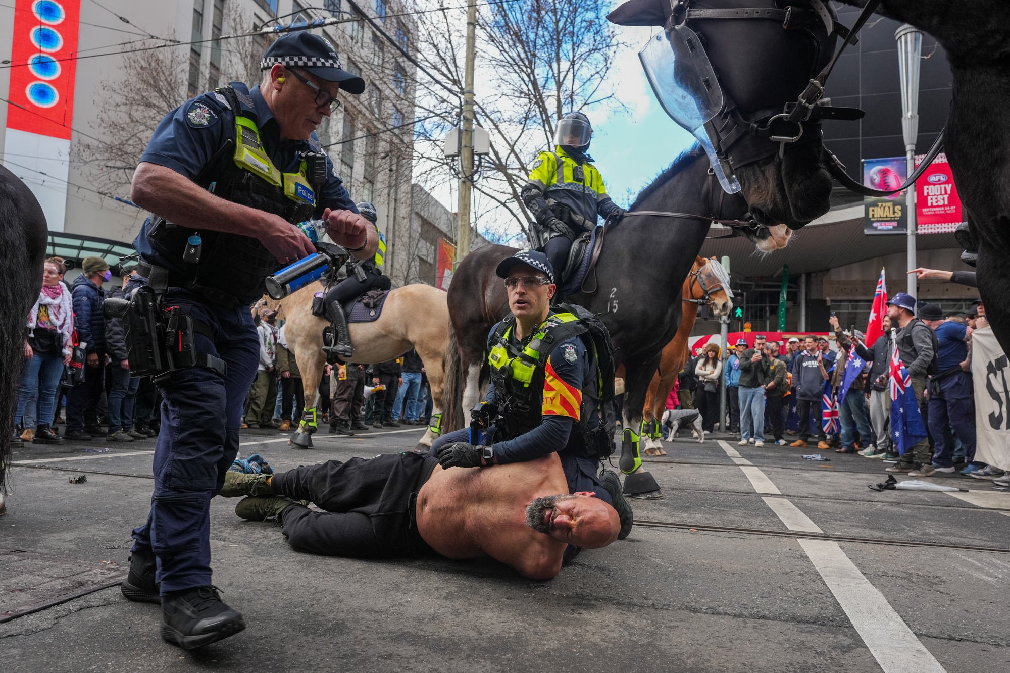 Police arrest a protester during anti immigration rallies and counter protests in Melbourne.
