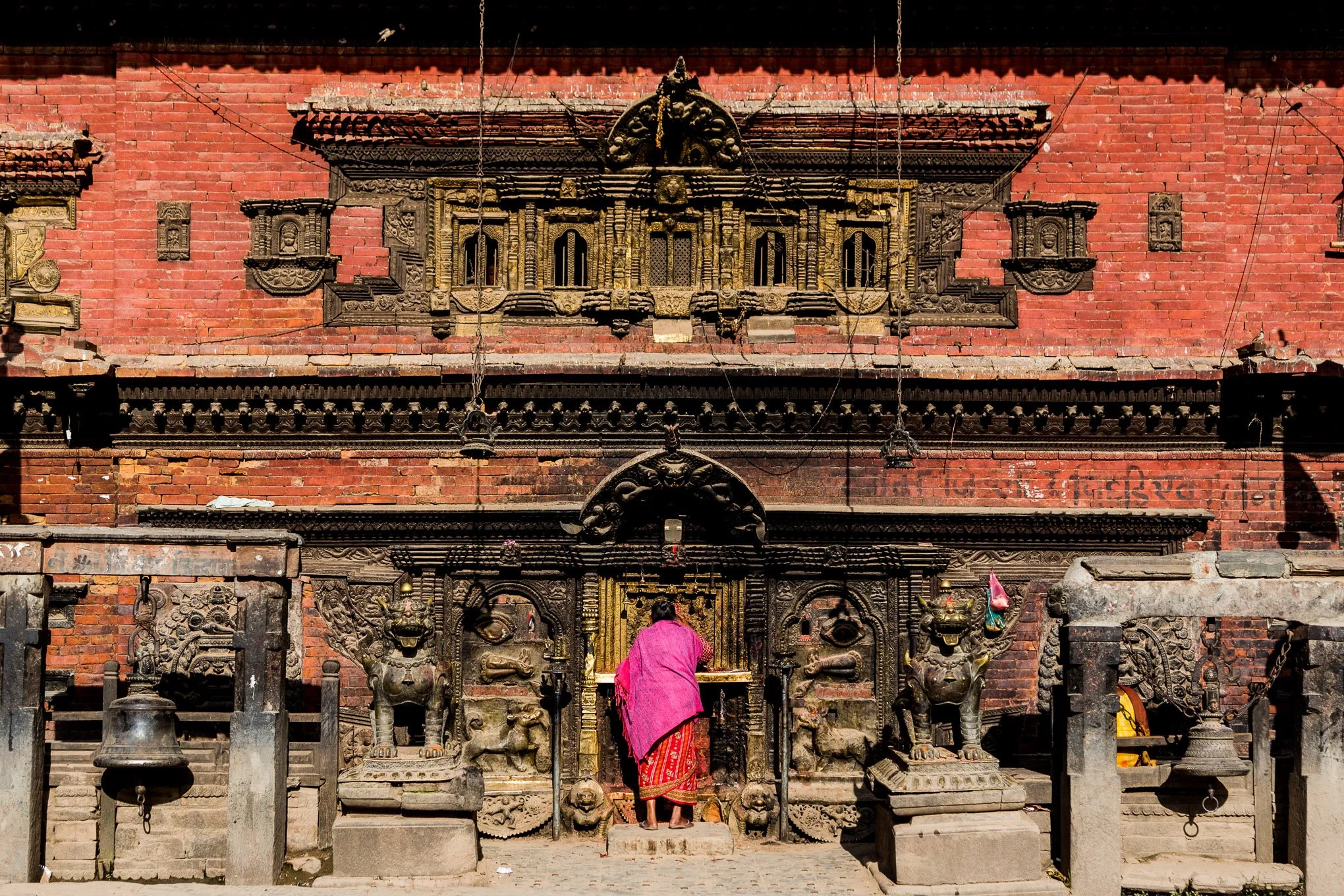 A Hindu woman makes an offering at Bhairavnath Temple in Bhaktapur, Nepal.