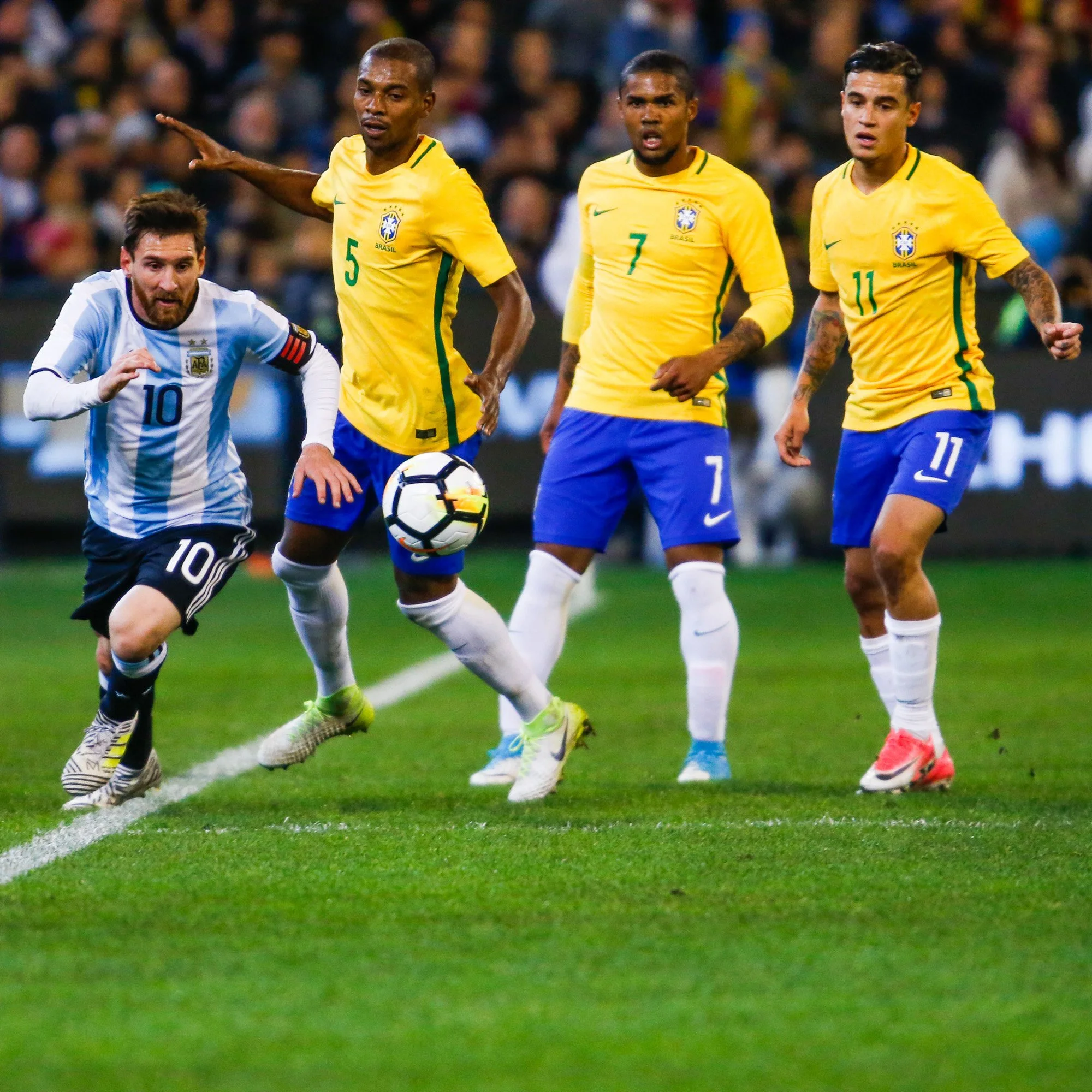 Lionel Messi of Argentina is contested by three Brazilian players as they look on