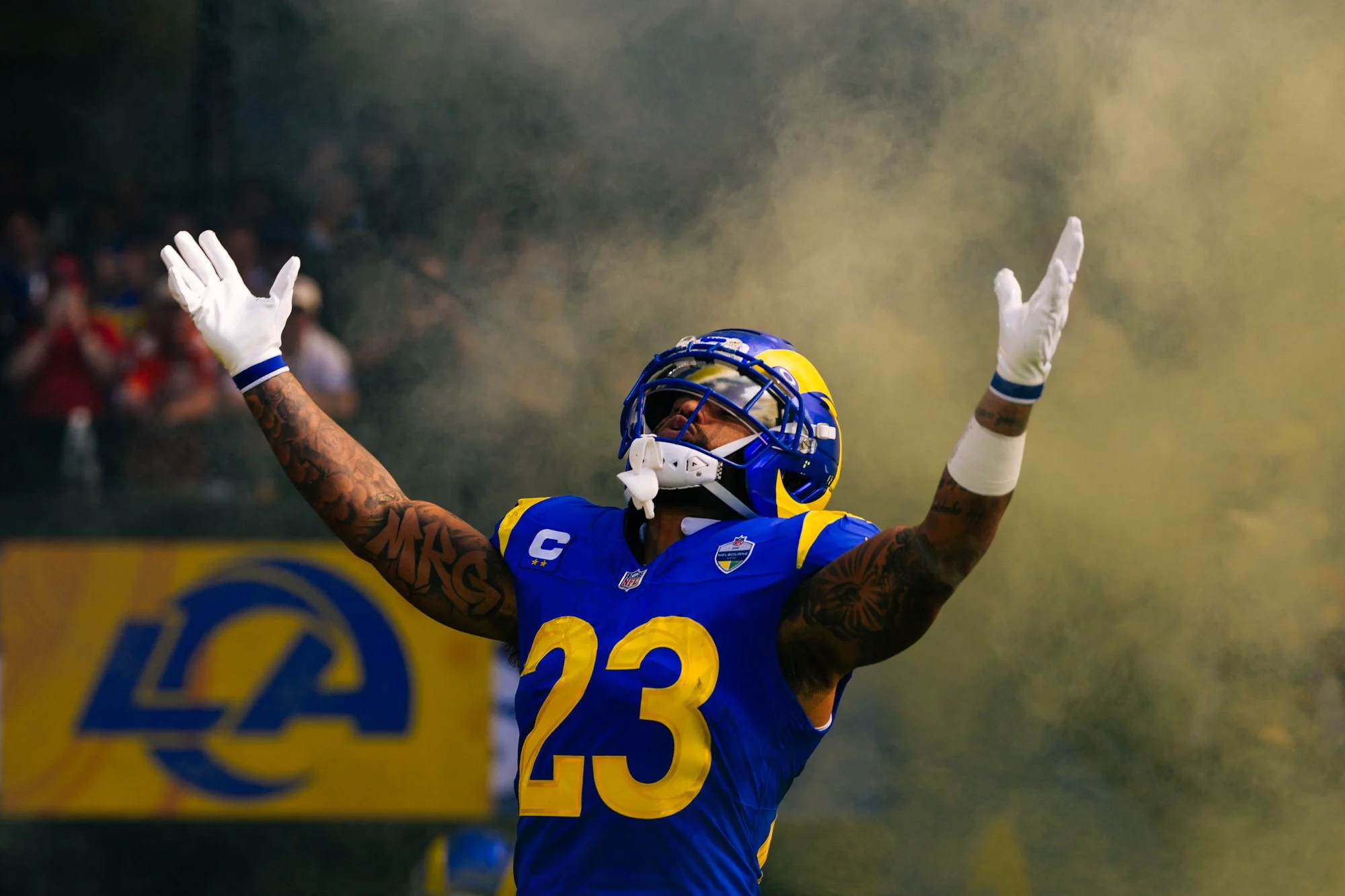 Los Angeles Rams running back Kyren Williams raises his arms during the team entrance before an NFL game at the Melbourne Cricket Ground.