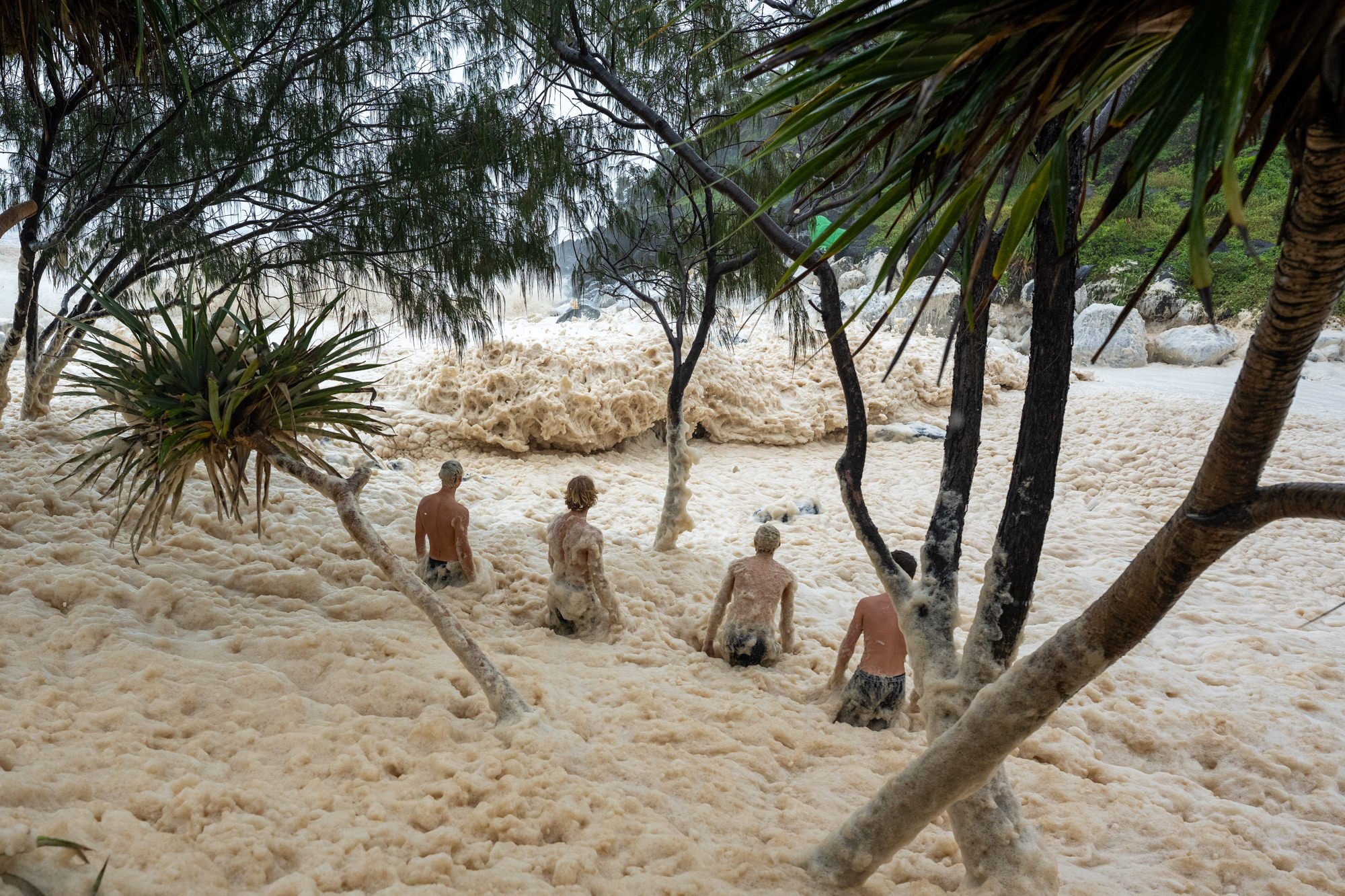 A group of people move away from a crashing wave at Tweed Heads as Tropical Cyclone Alfred approaches Australia’s east coast.