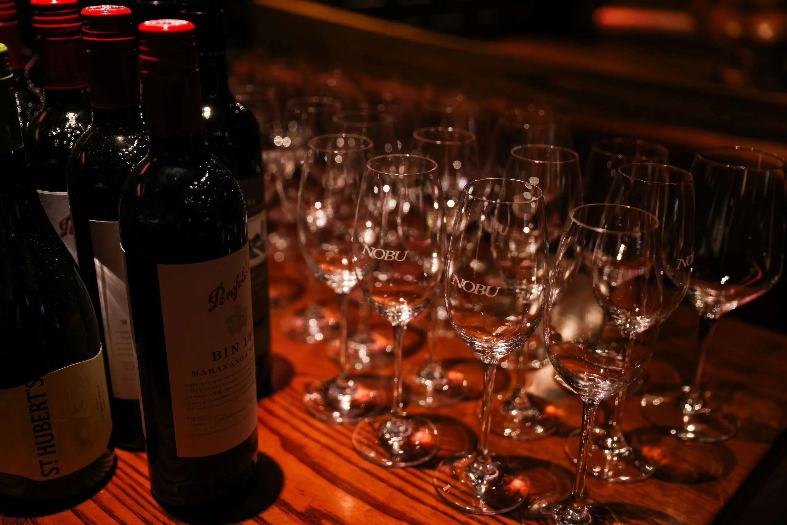 Event photographer Details such as wine bottles and glasses at Nobu Melbourne