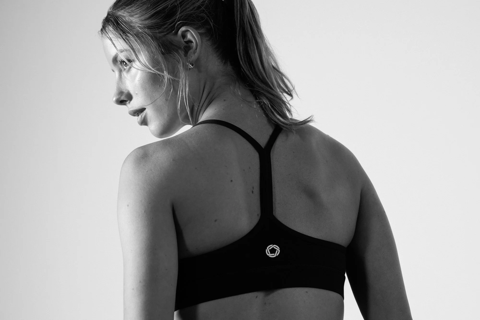 Black and white portrait of a woman wearing activewear.
