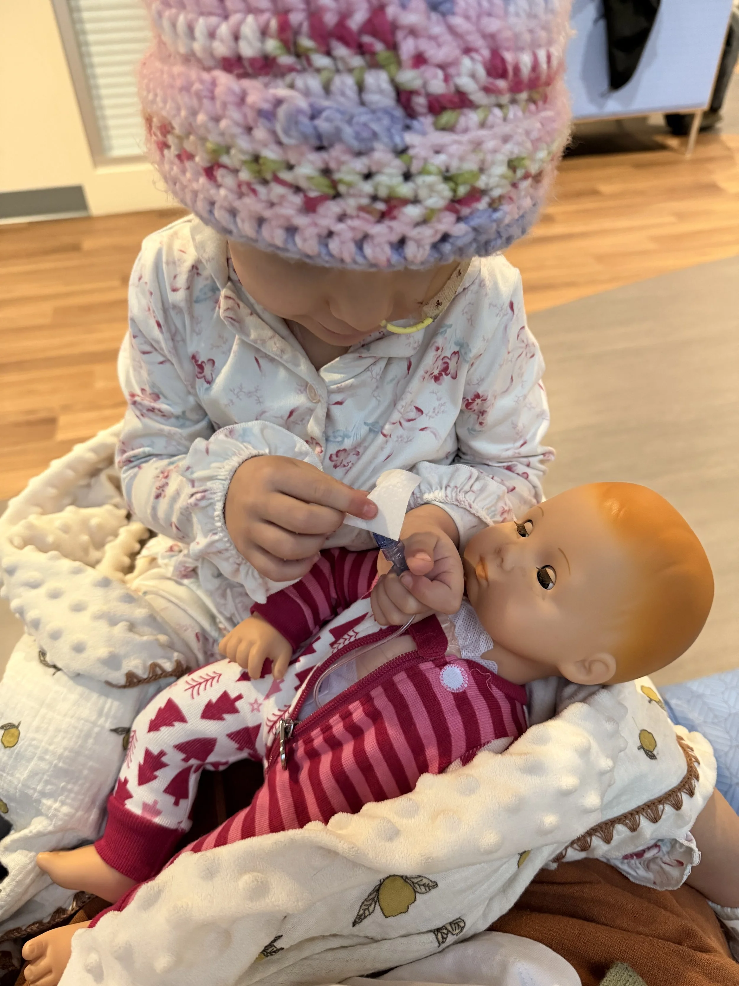 Baby helping Baby