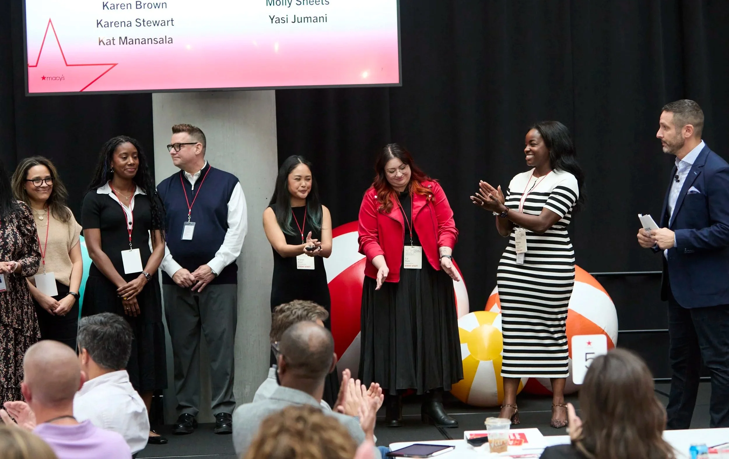 Karena Stewart on stage at a Macy's Leadership Development Summit, addressing a full cohort of senior leaders.