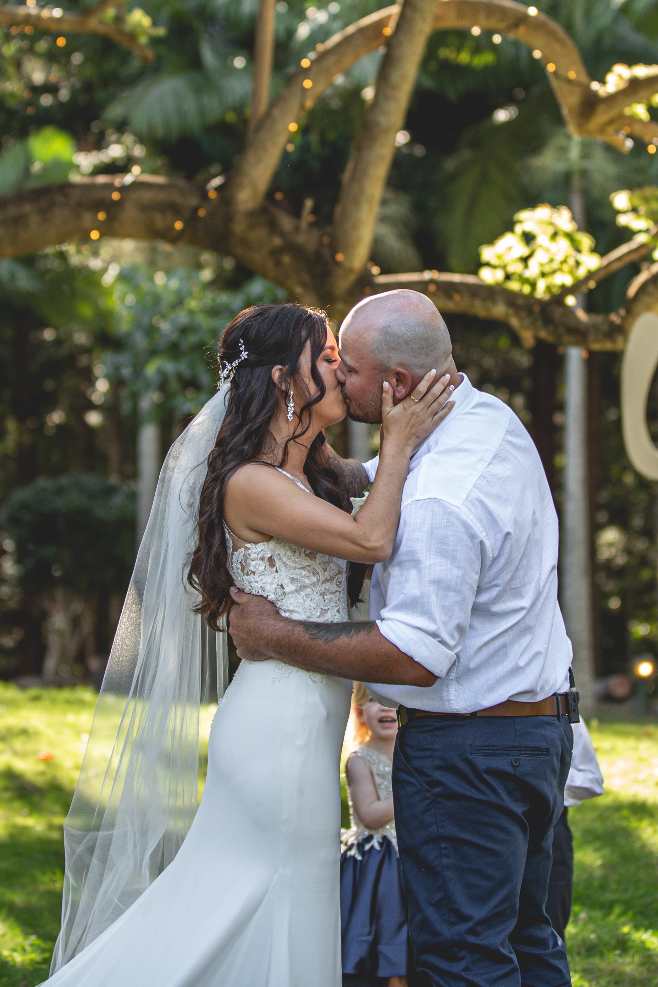 Couple share first kiss under giant tree at Coolabah Downs Private Estate. 