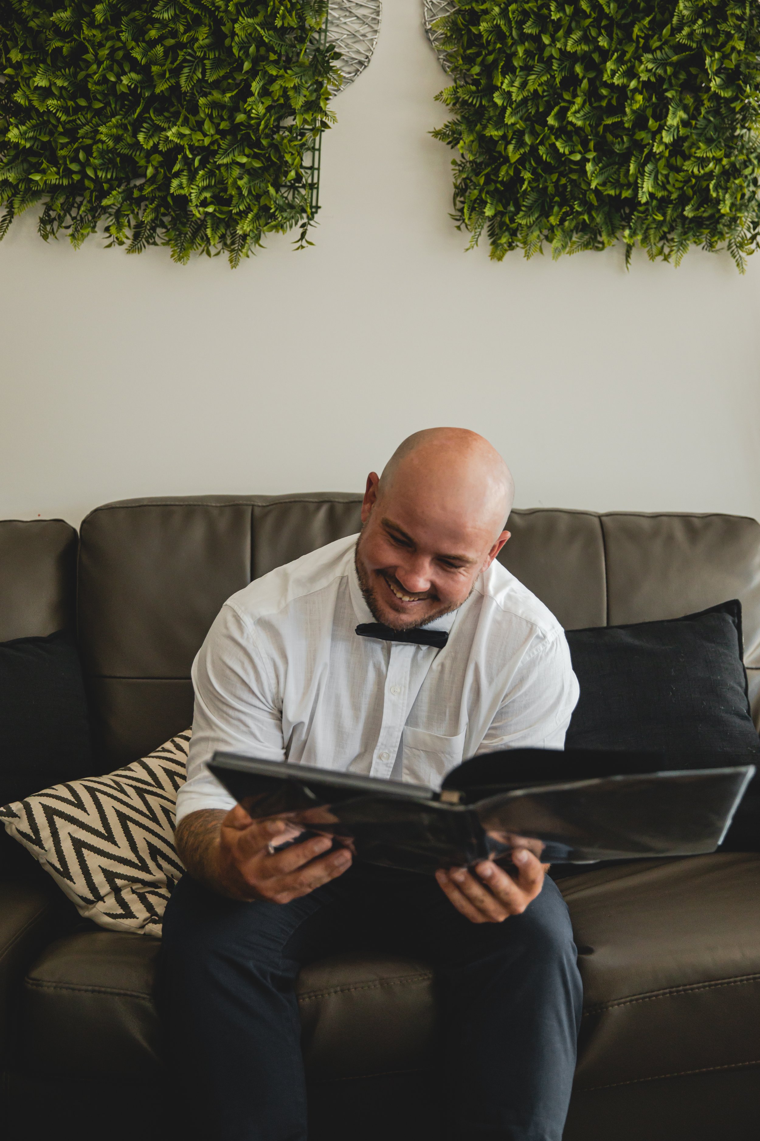 Portrait of male looking at boudoir album of their wife. 