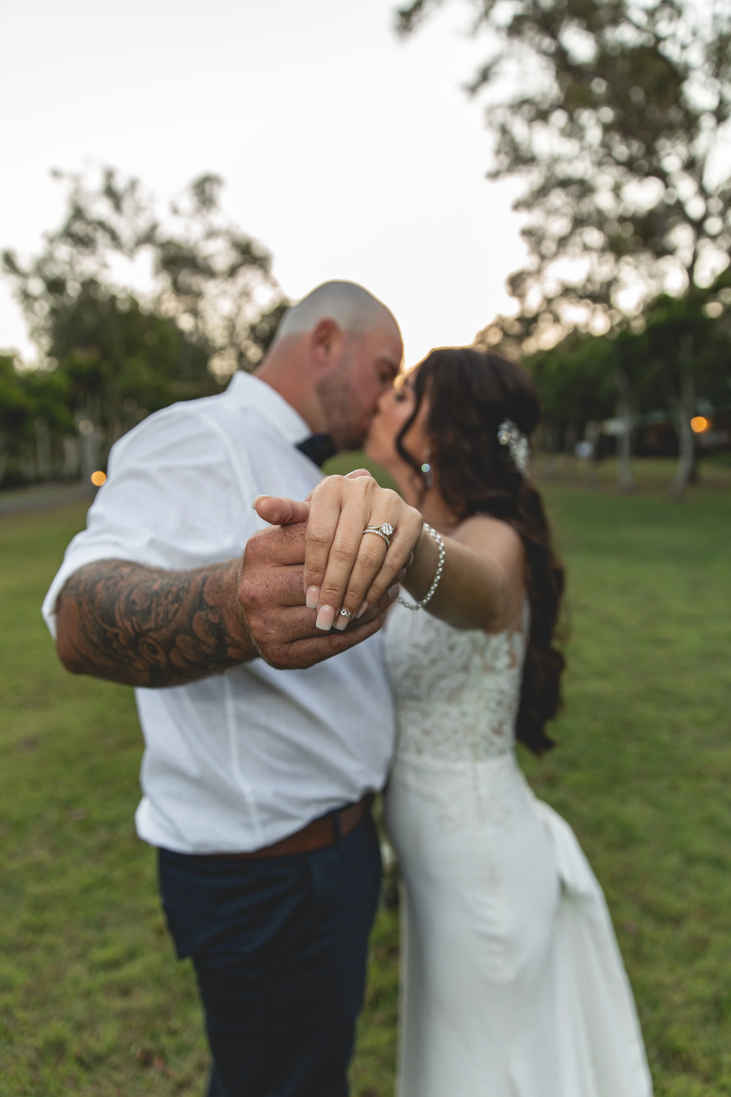 Couple poses with hands out showing wedding rings at Coolabah Downs Private Estate..