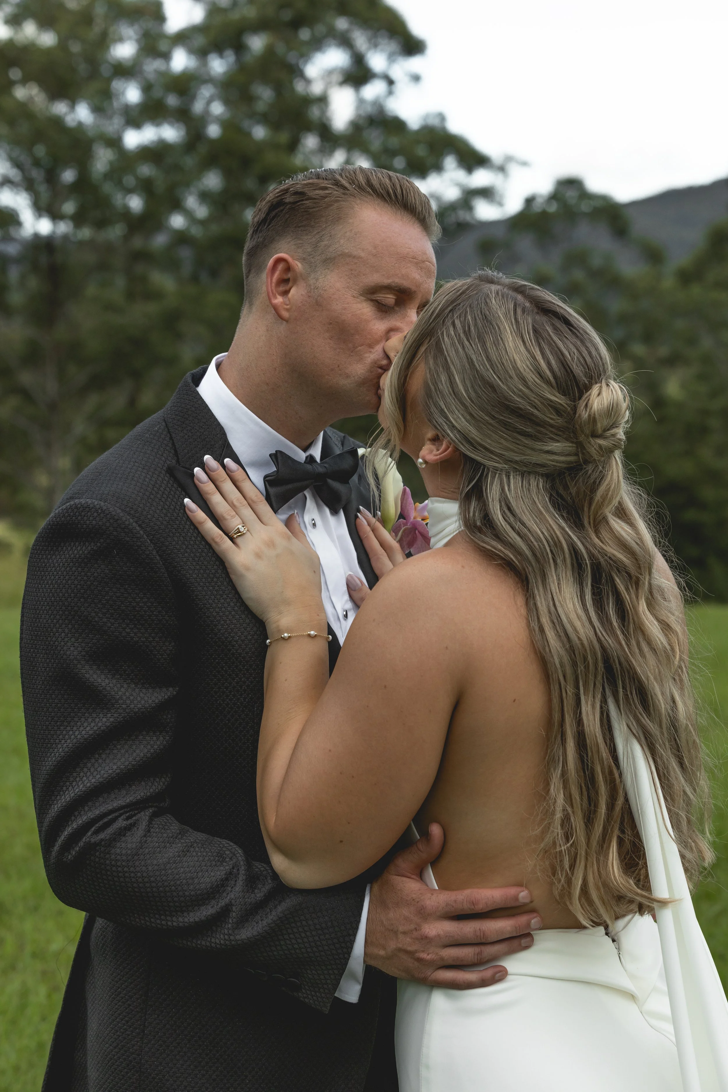 Couple share a kiss at their wedding on top of hill at Selah Valley Estate. 