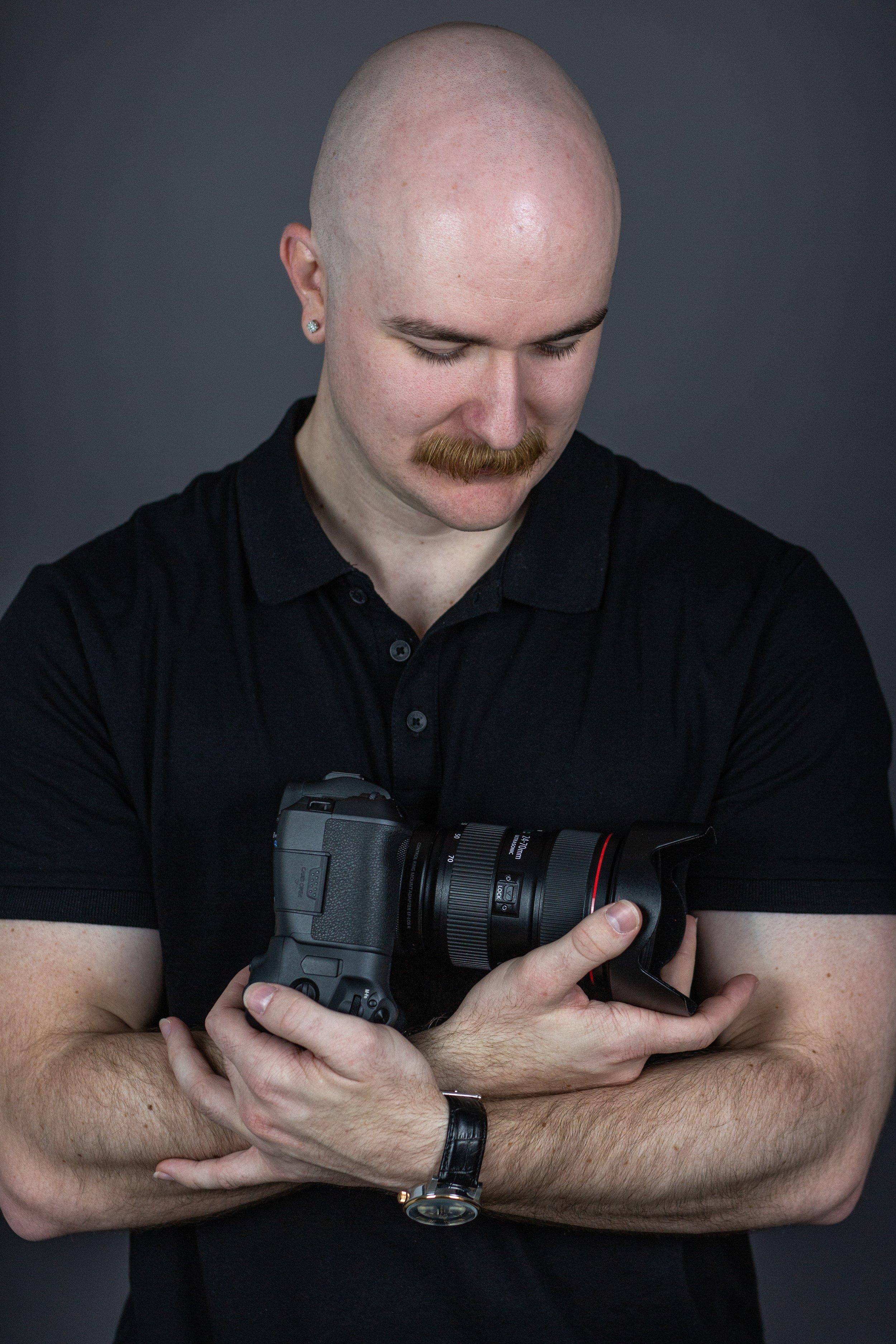 Joden Furlonger holds camera in arms.