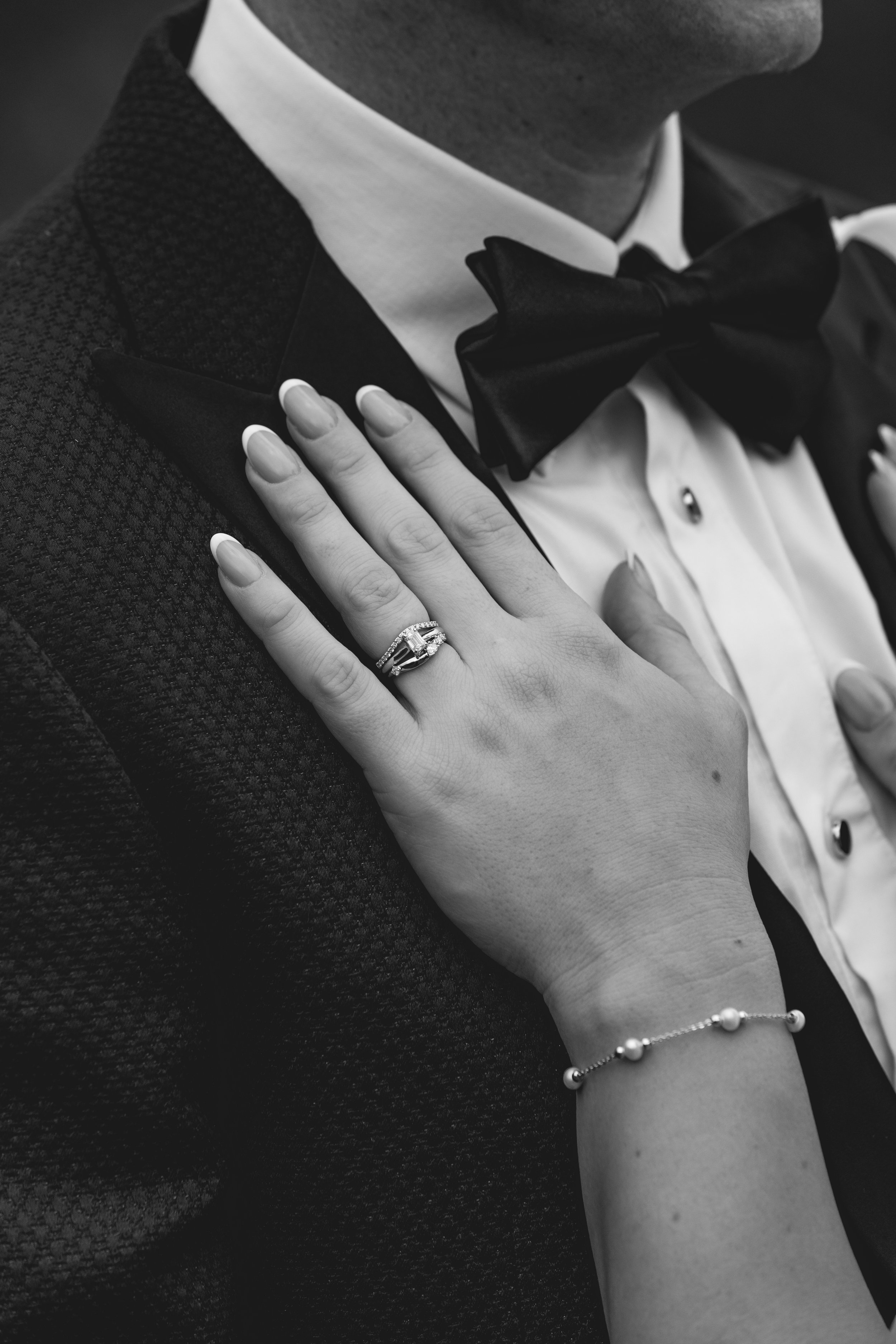 Black and white detailed close up of wedding rings on hand at Selah Valley Estate.