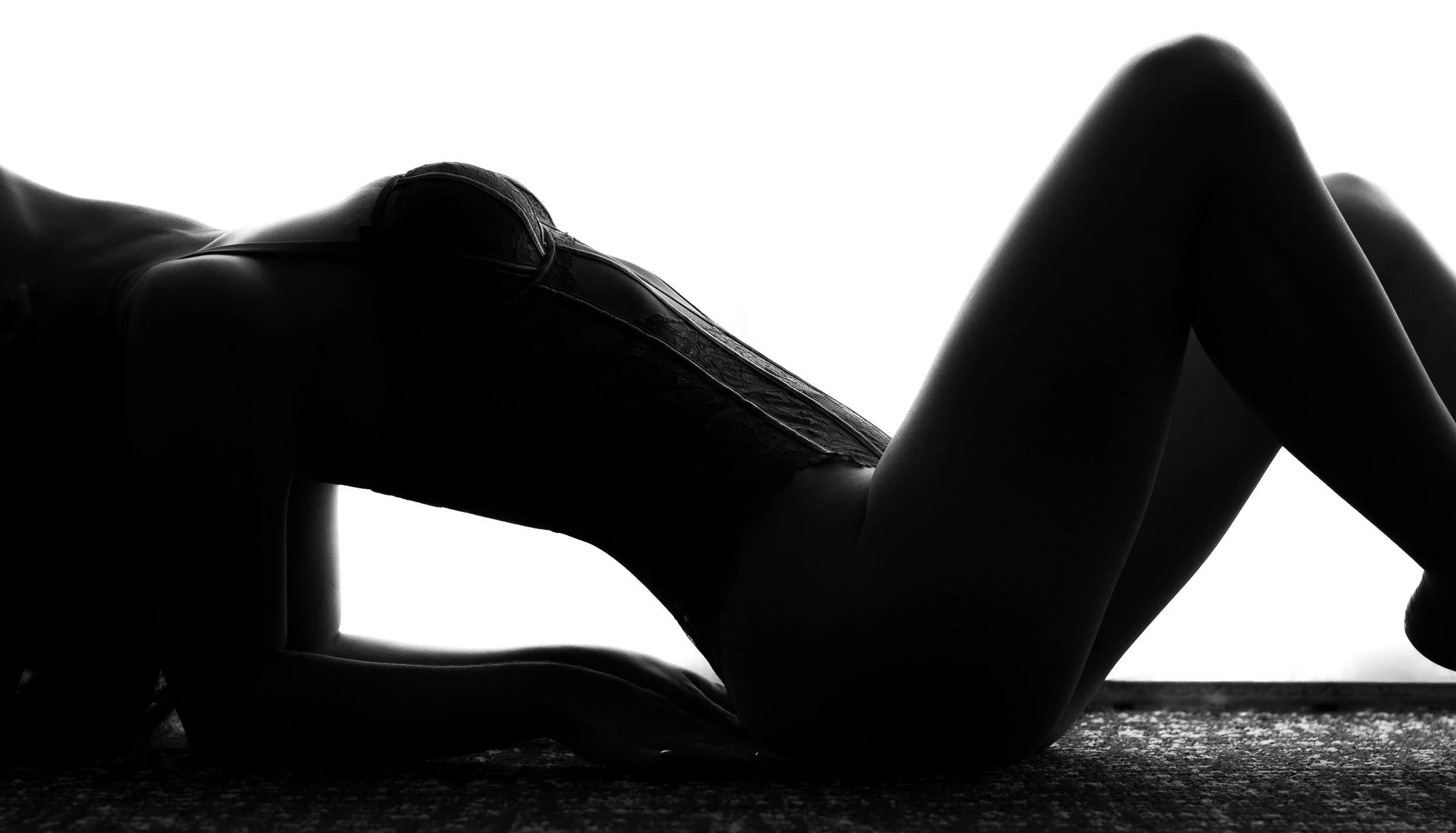 Sensual black and white boudoir portrait in a sunlit Brisbane hotel room.