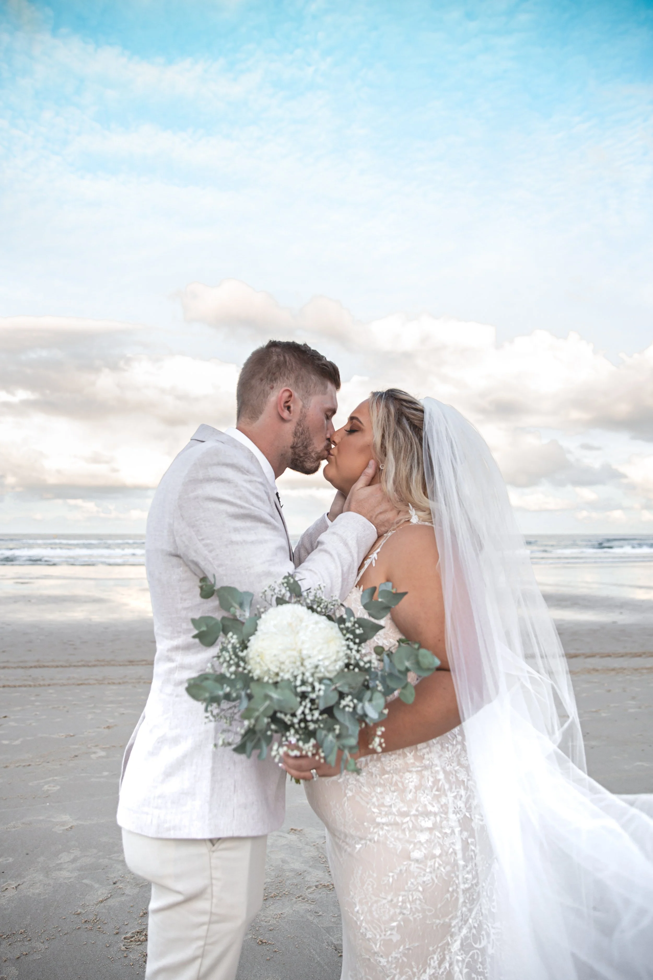 couple getting married on a Gold Coast beach sharing a kiss.