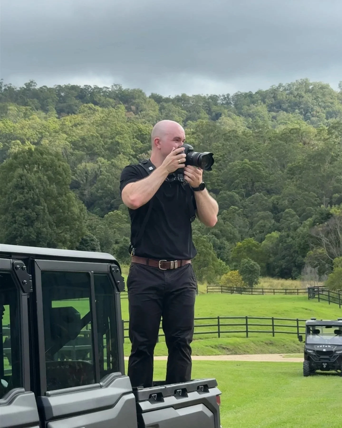 Joden Furlonger stands in back of Polaris ATV for wedding at Selah Valley Estate.