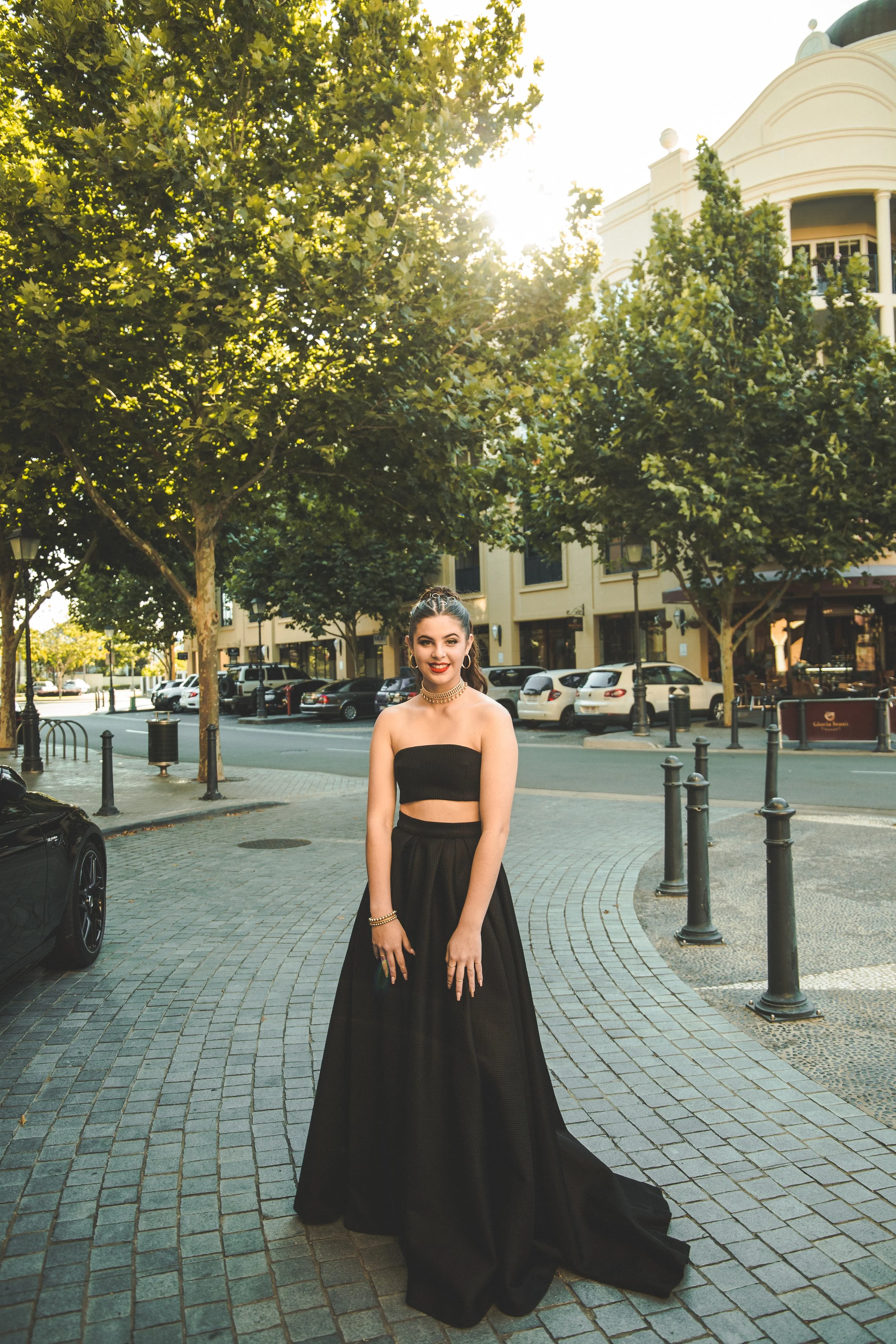 Formal student in black dress modelling during golden sunset at Emerald Lakes.