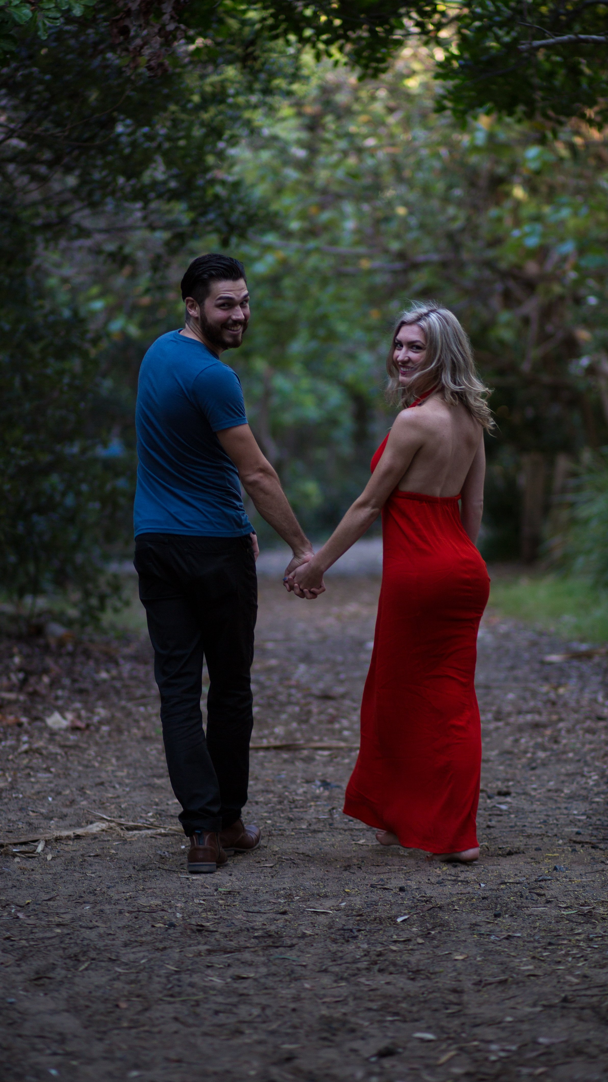 Couple looking back while walking the sandy path to Fingal Lighthouse Lookout. 