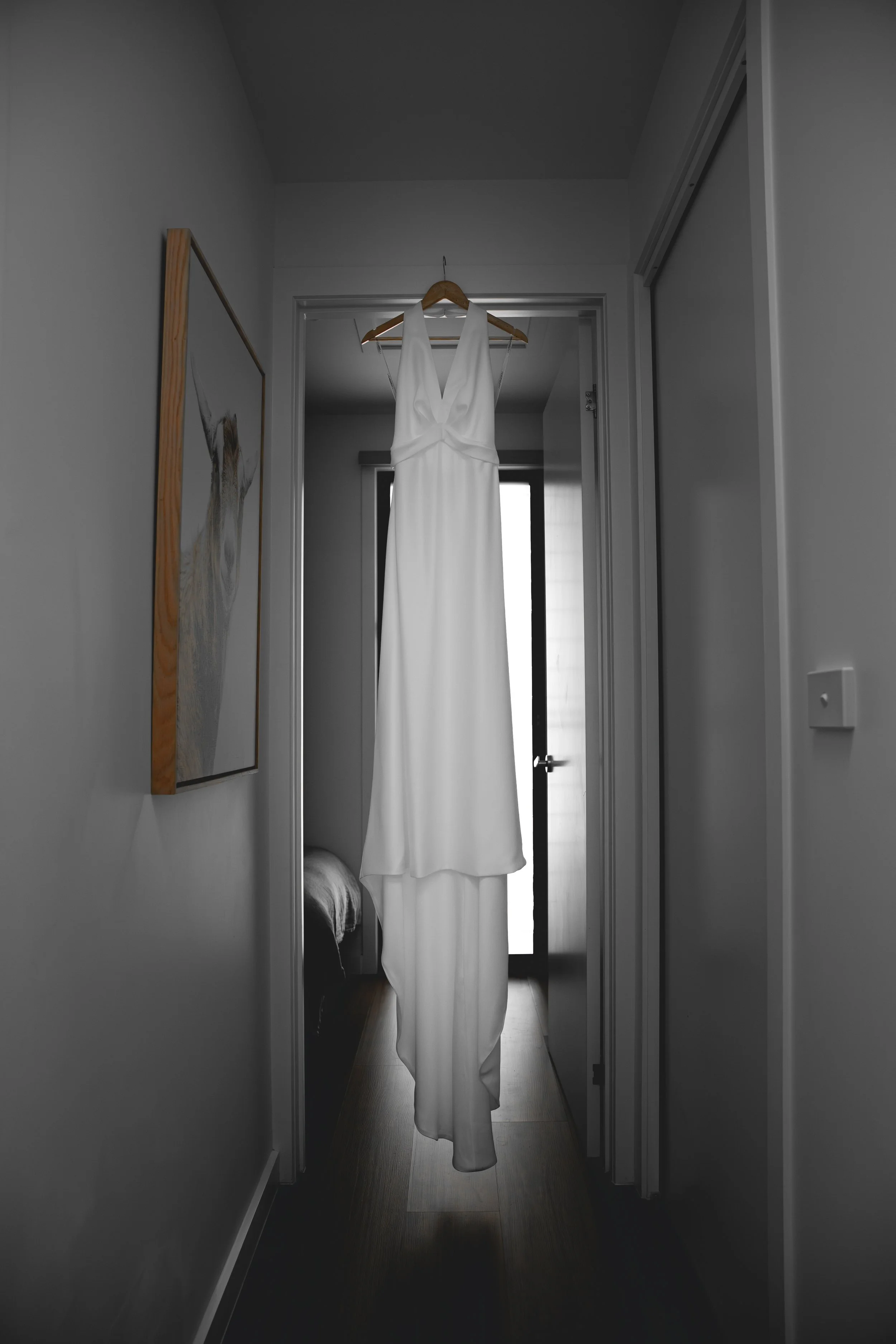 Wedding dress hanging in hallway of Selah Valley Estate Creekside Lodge 
