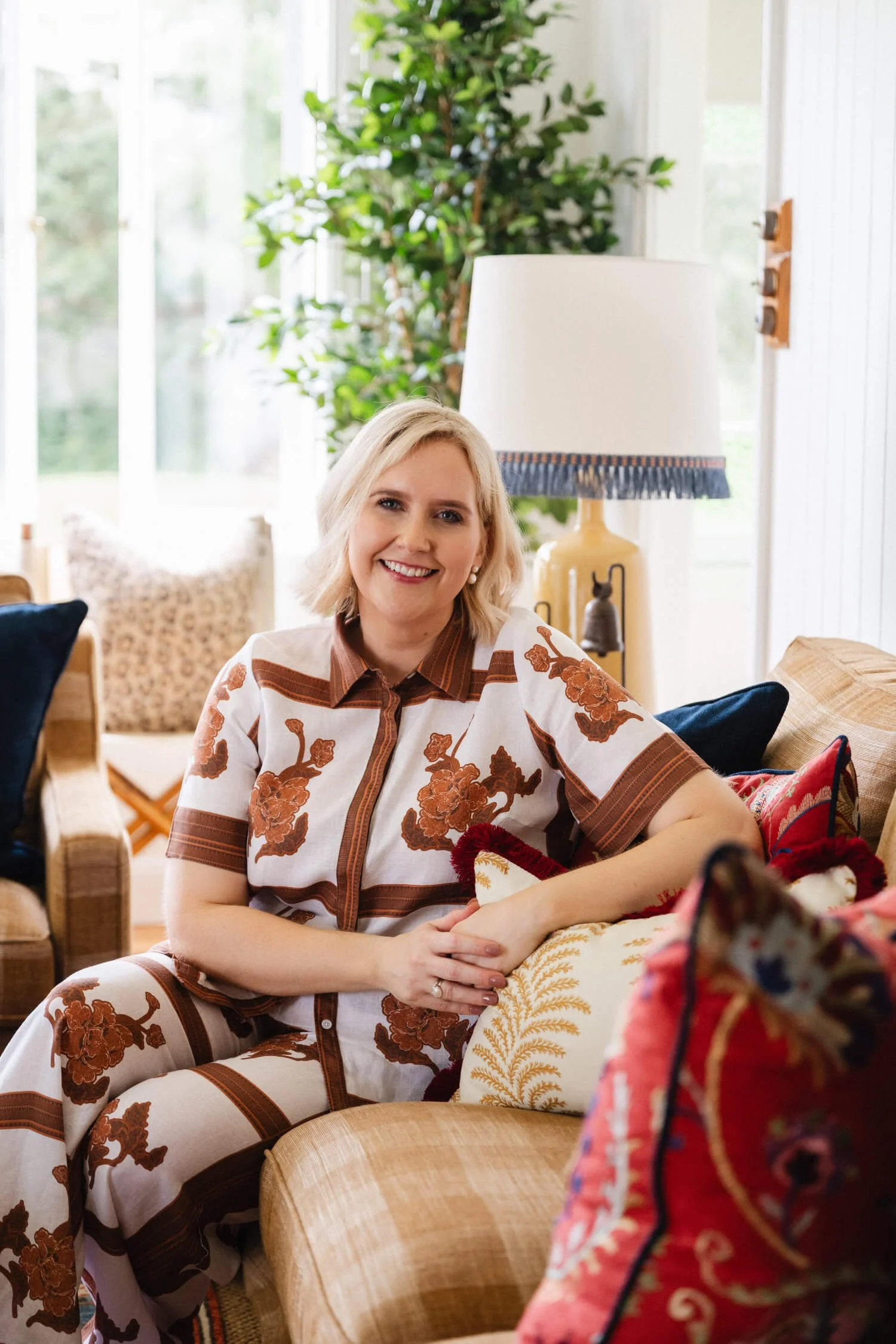 Julia Monaghan of Biju Interiors sitting on a sofa - singleborder