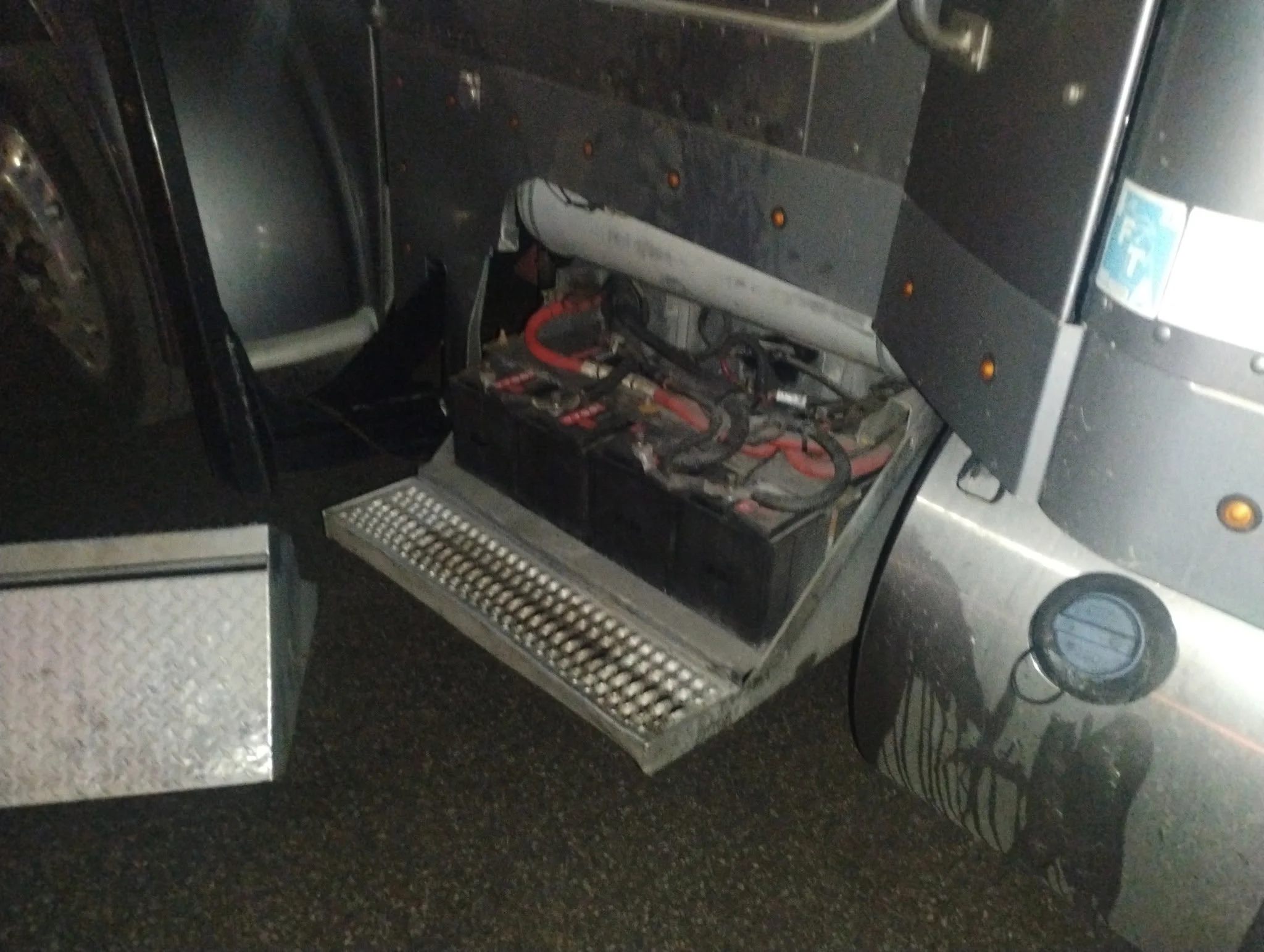 The image shows the interior of a washing machine or dryer with its front panel removed, exposing the drum and internal wiring.
