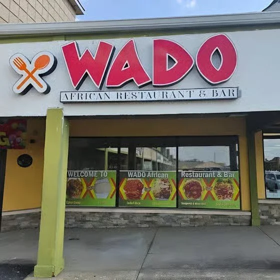 Exterior of WADO African Restaurant & Bar with colorful signage and window displays
