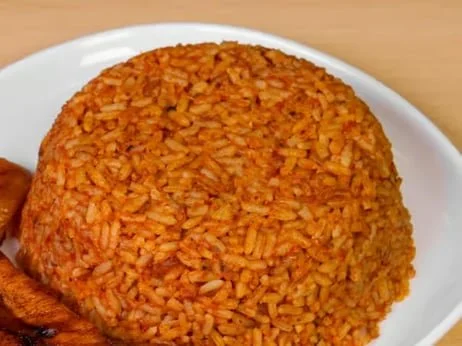 A large serving of fried rice on a white plate.