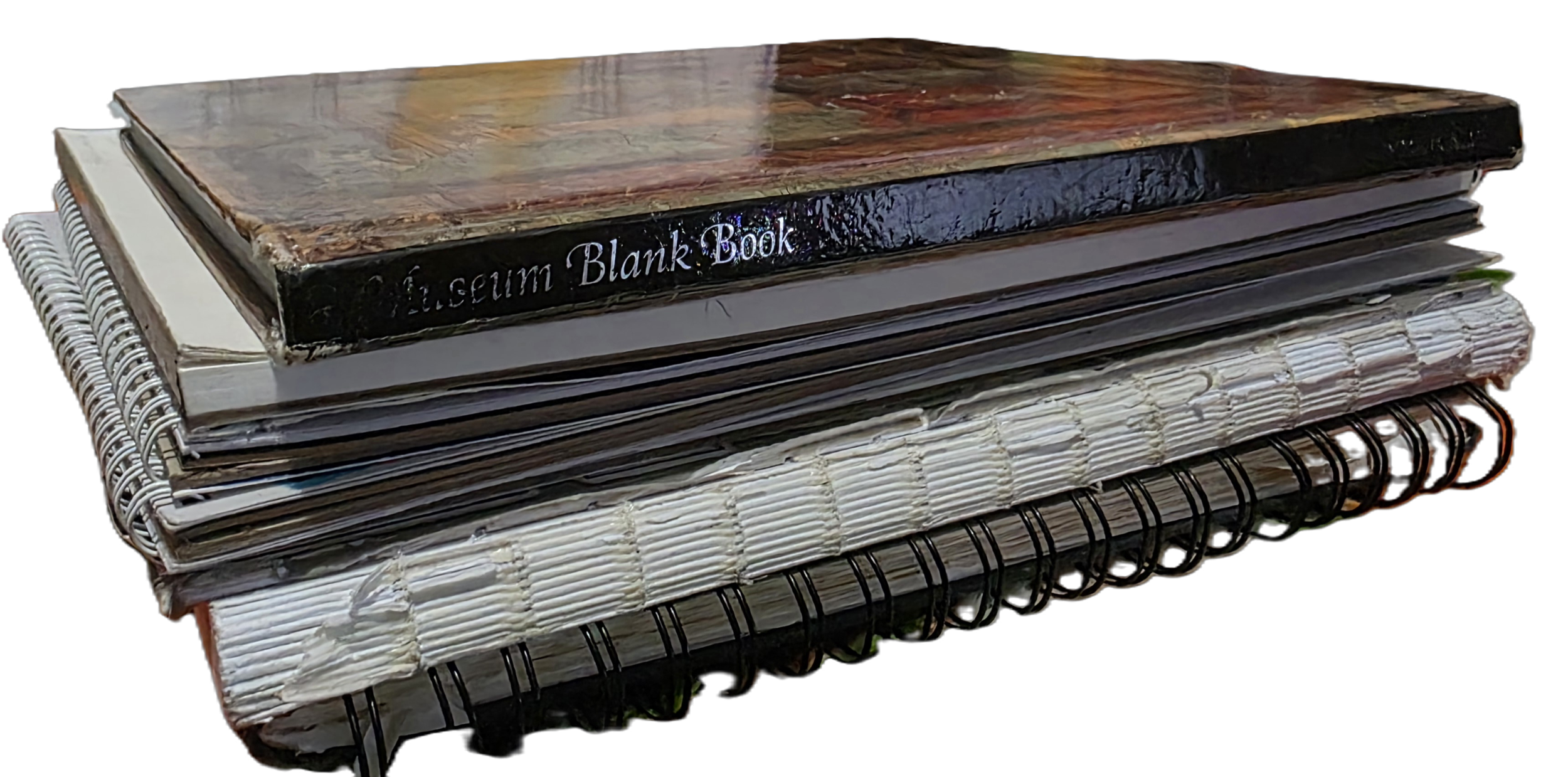 Stack of notebooks, binders, and a black book labeled 'Altium Blank Book' on top, viewed from the side against a black background.