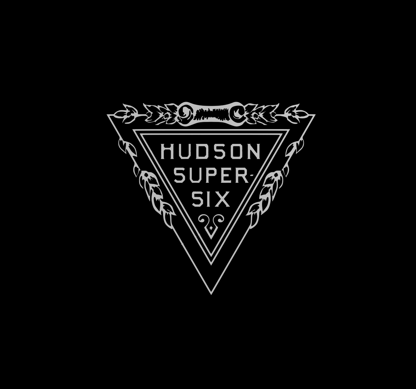 A black background with a white triangular emblem in the center. Inside the triangle, the words "HUDSON SUPER SIX" are displayed in a vintage font. Surrounding the triangle is an ornate laurel branch design.