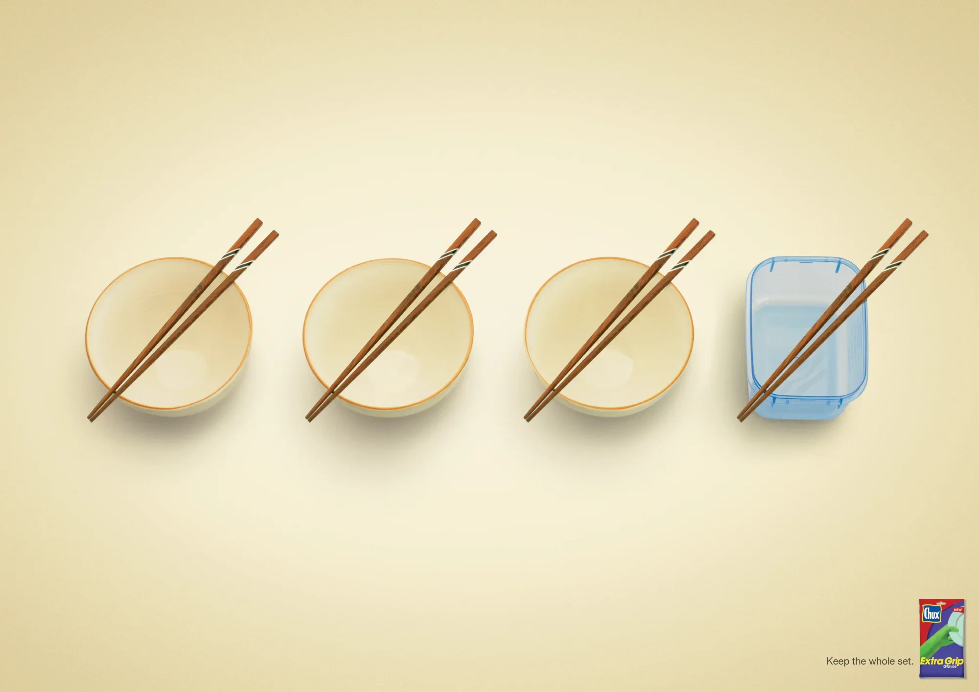 Three empty bowls and a plastic container with chopsticks on a yellow surface