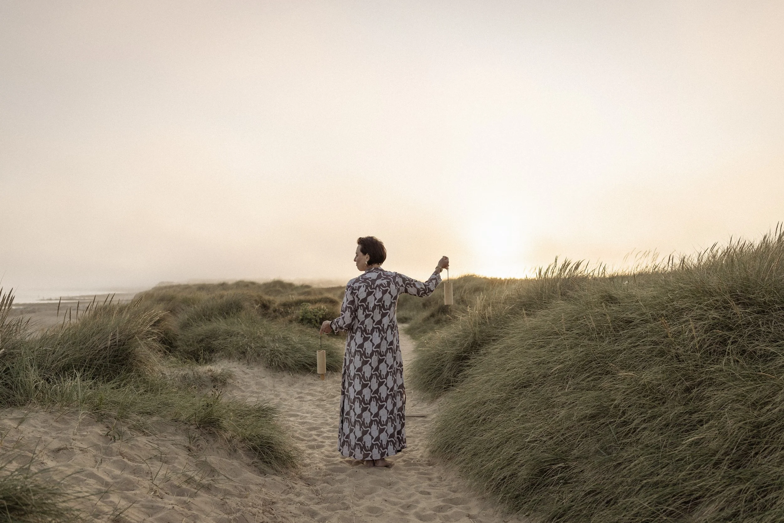 Lou Buck using healing instruments on the beach