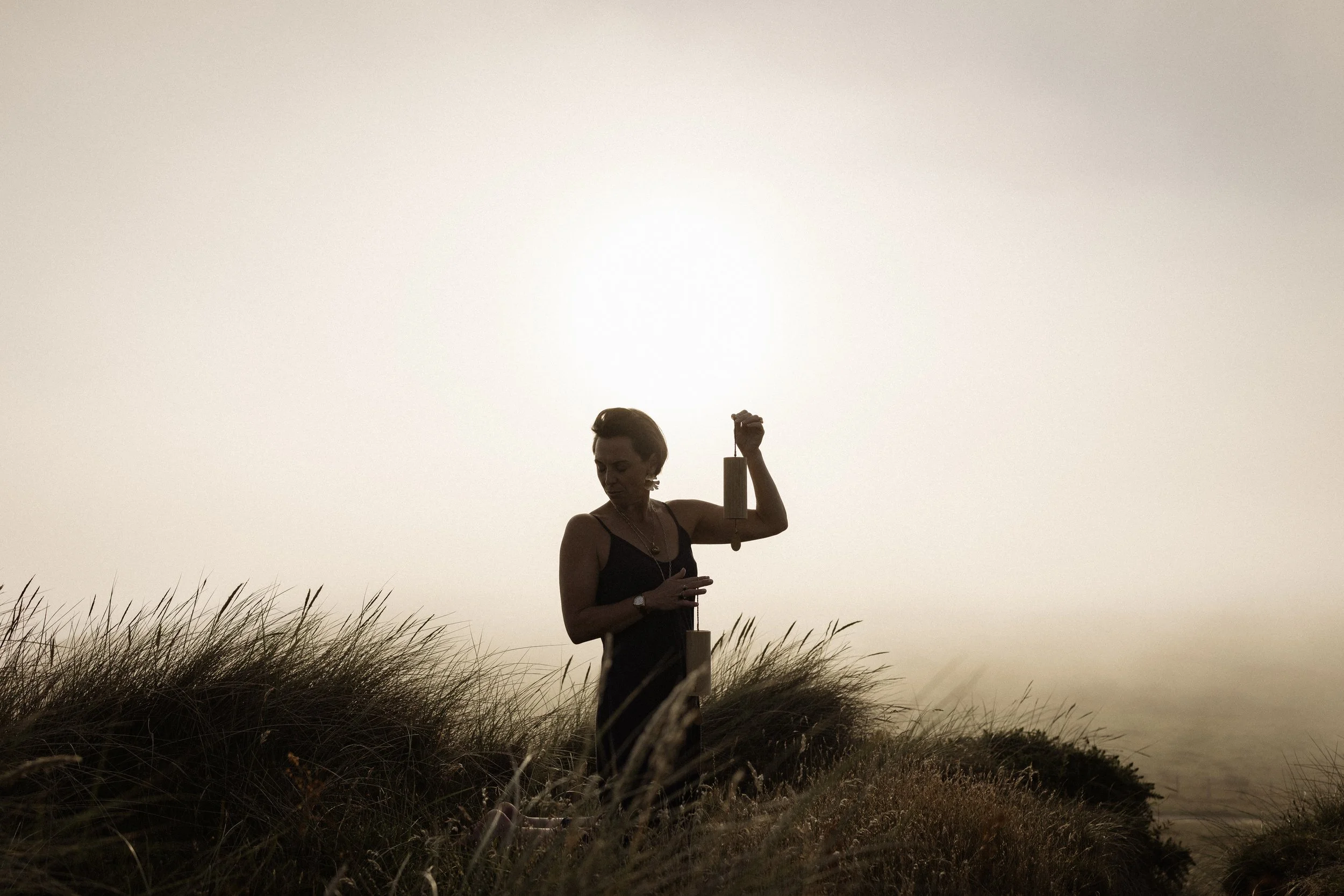 Lou buck at the beach with healing instrument.