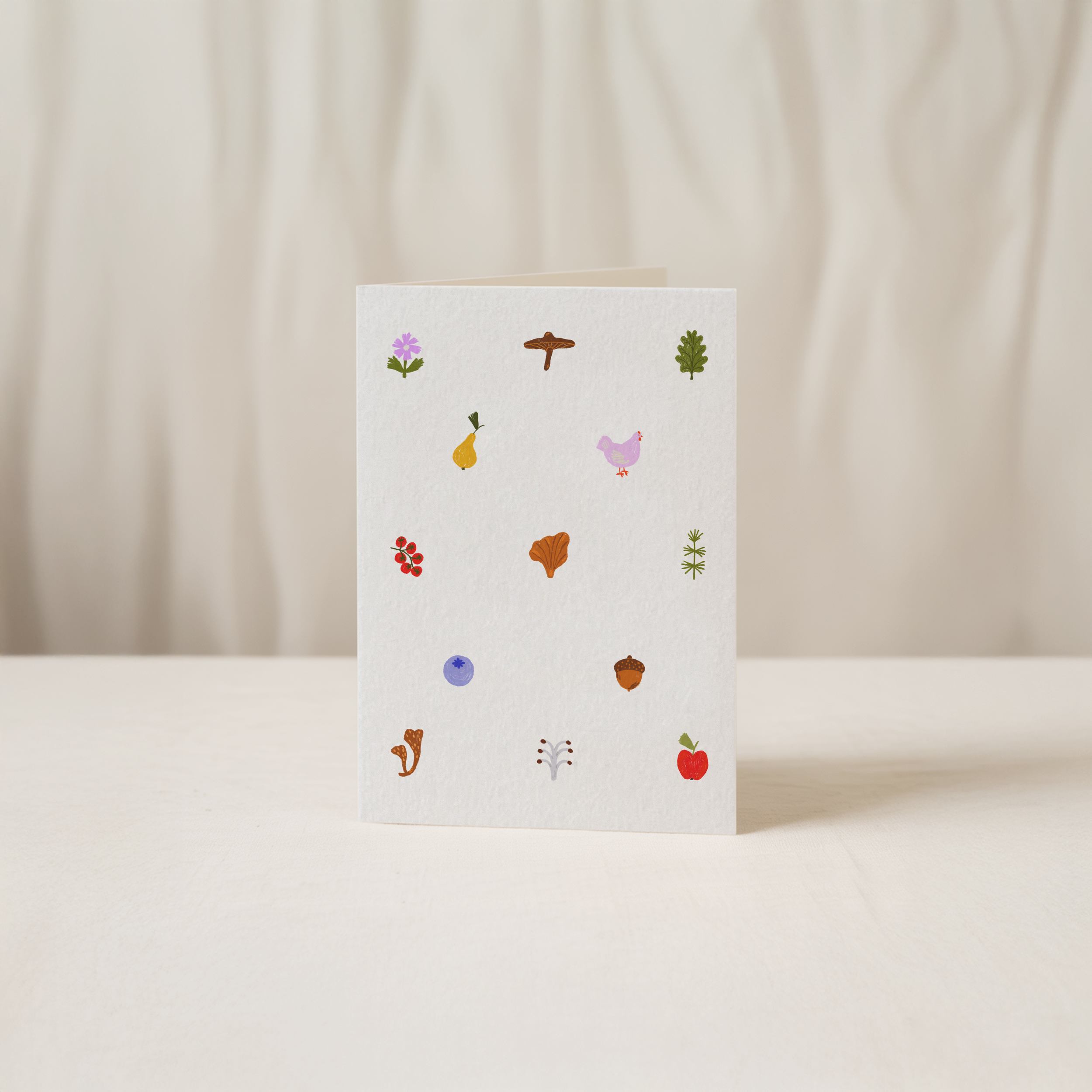 Blank vertical greeting card featuring a whimsical woodland pattern with a tiny mushroom, acorn, leaves, and bird, everyday original illustration by Kadna Anda