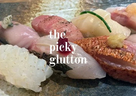 Assorted sushi pieces on a plate with the text 'the picky glutton' superimposed.