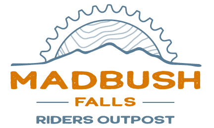 Logo for Madbush Falls Riders Outpost, featuring a gear and mountain design in the background with bold orange and blue text.