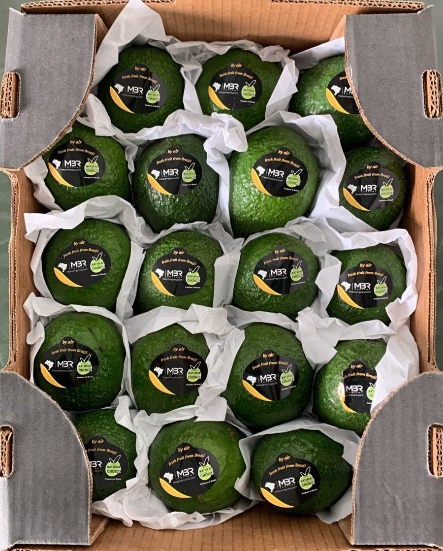 green hass avocados with natural choice brand yellow and black stickers saying "fresh fruit from brazil by air"