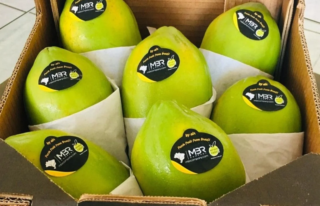 papaya golden with natural choice brand black and yellow stickers saying "fresh fruit from brazil by air"