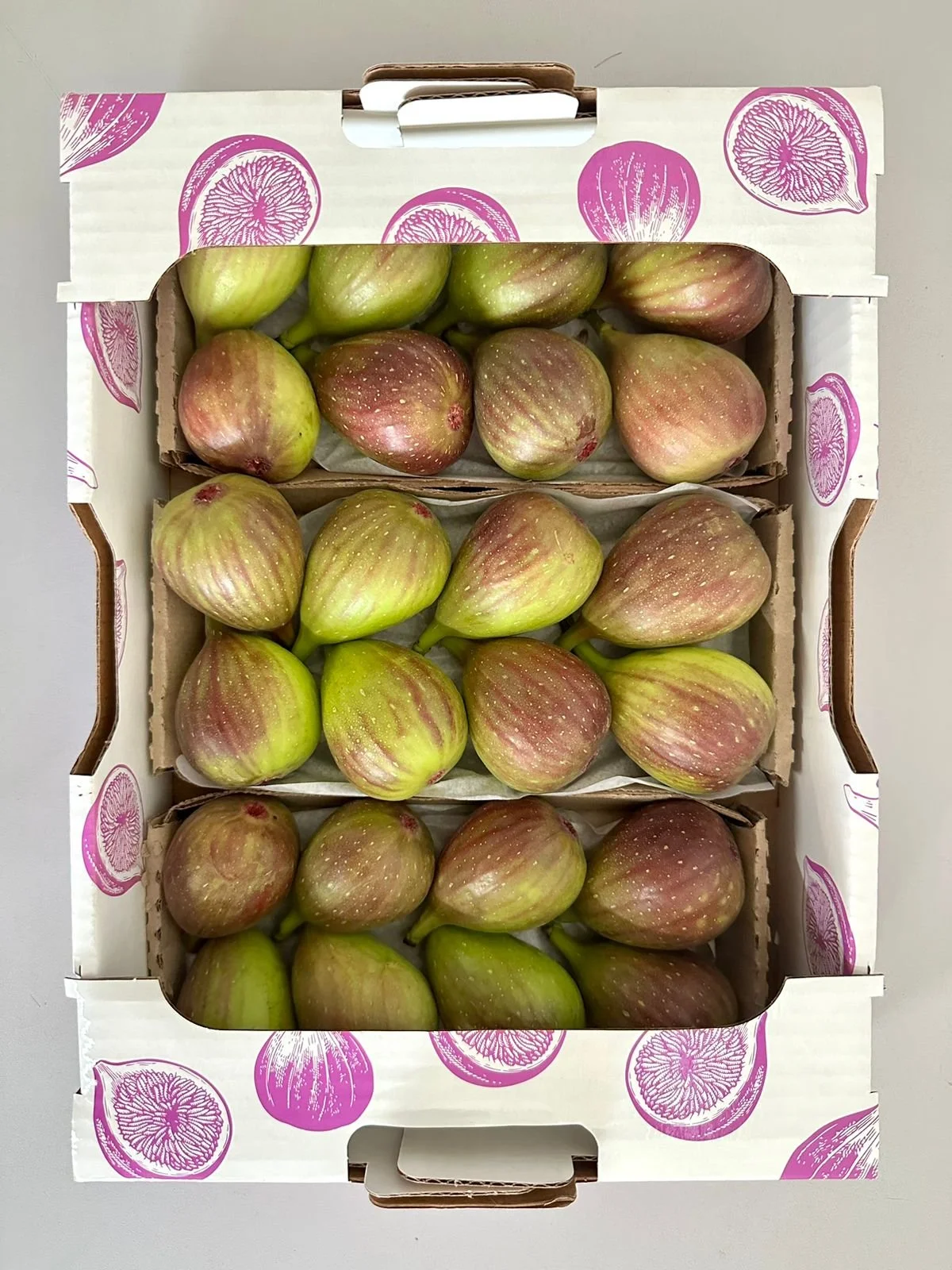 white box with purple fig drawings containing fresh purple figs from brazil