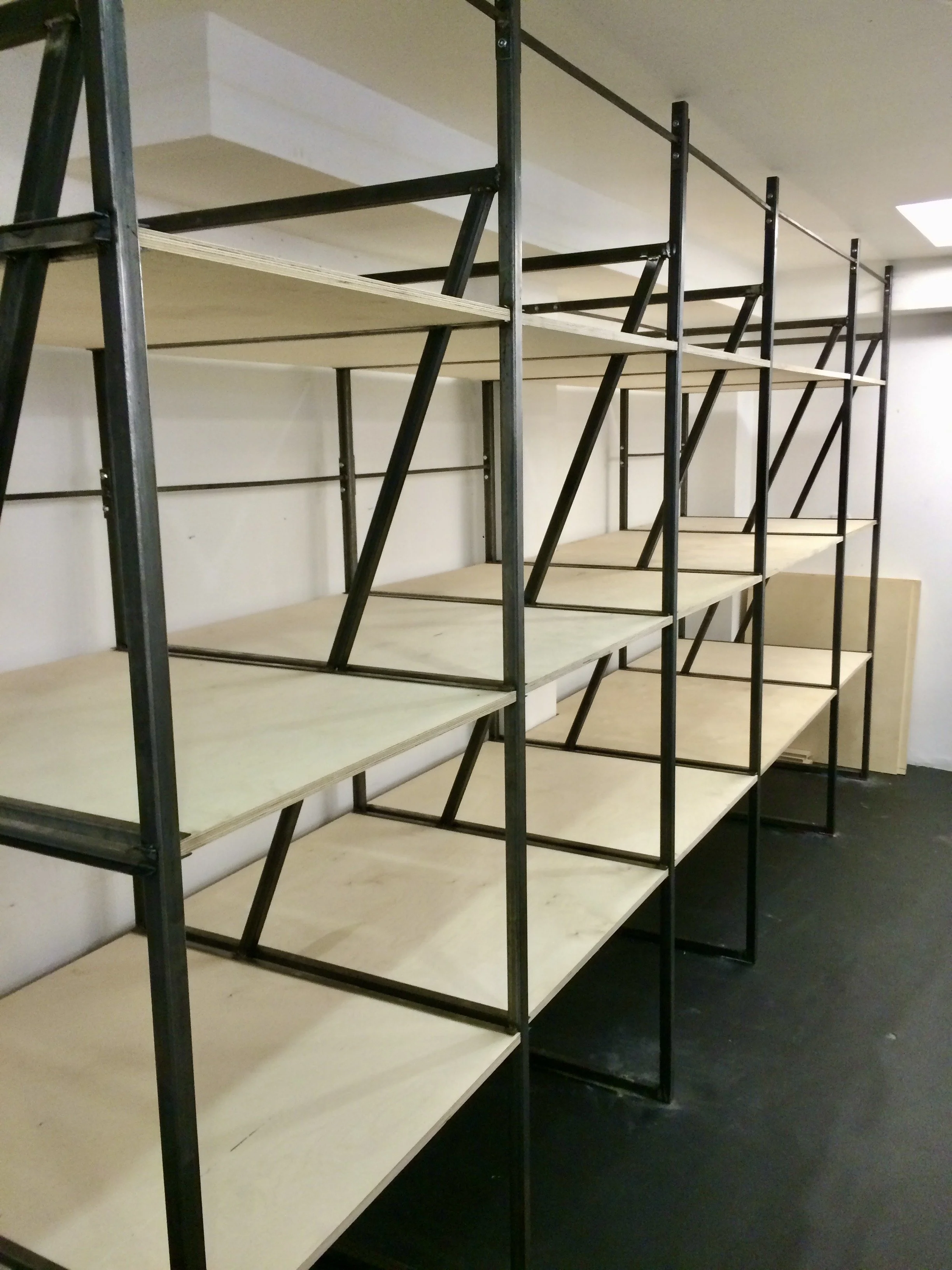 bespoke designed and built shelving system using steel and timber plywood