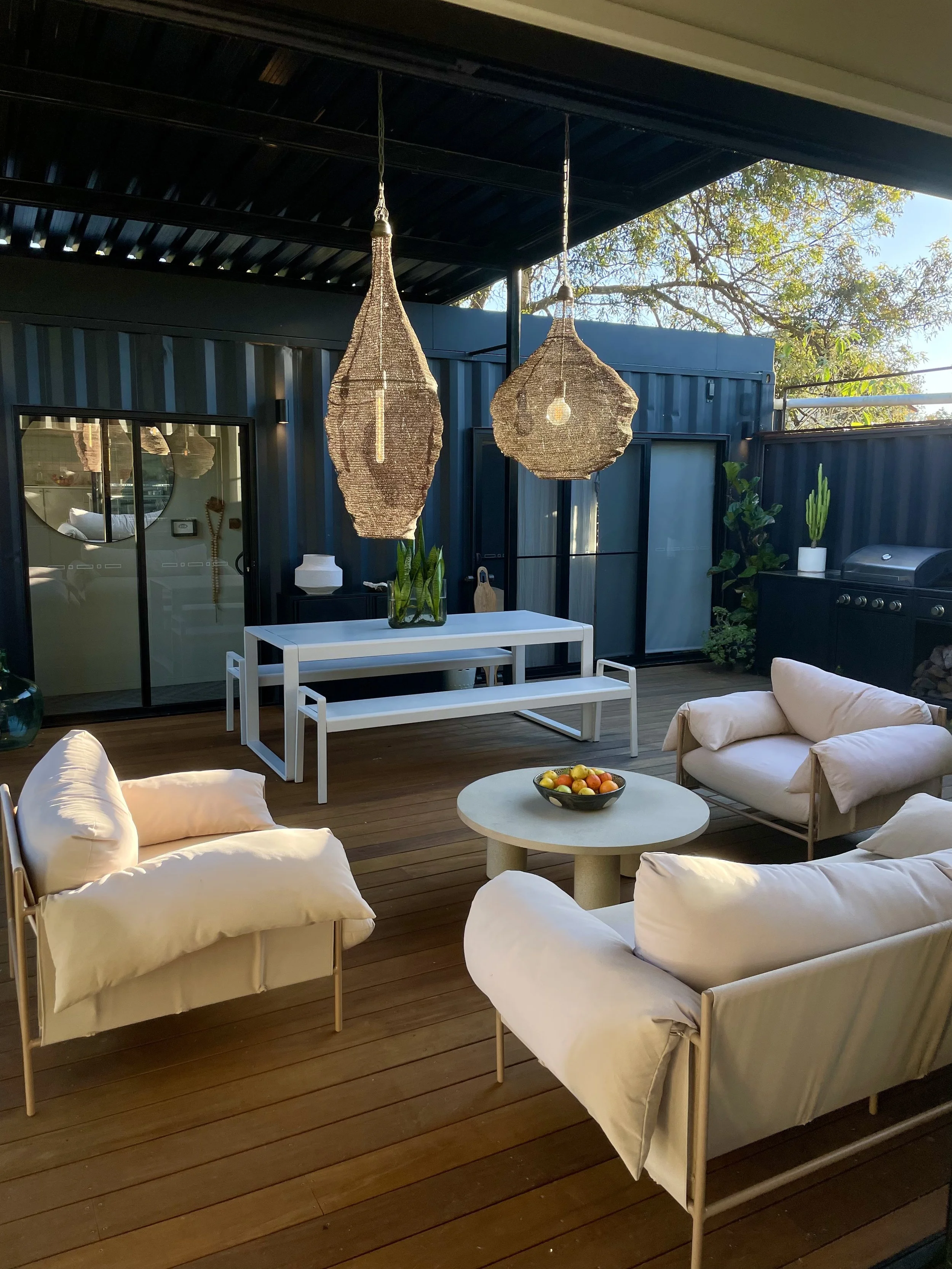 living area on an outside deck at a shipping container house 