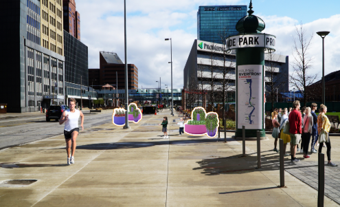 Sidewalk in an urban area with people walking, potted plants, and a signpost.