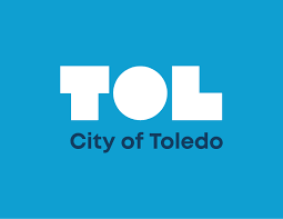 Logo of the City of Toledo with the acronym TOL in large white letters on a blue background.