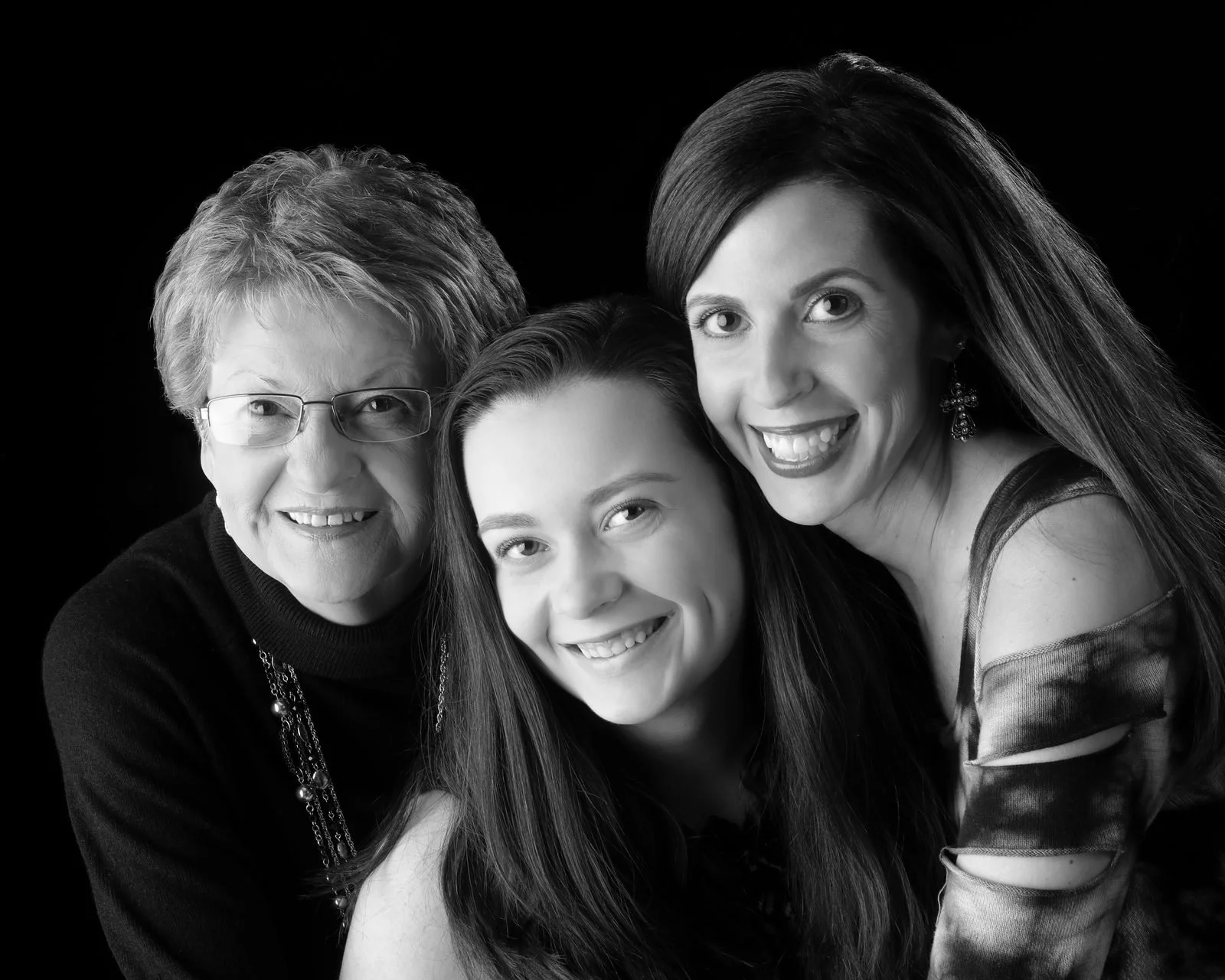 Three women of different ages smiling close together, black and white portrait by Joe Craig at Soulmarks in Dexter, Missouri