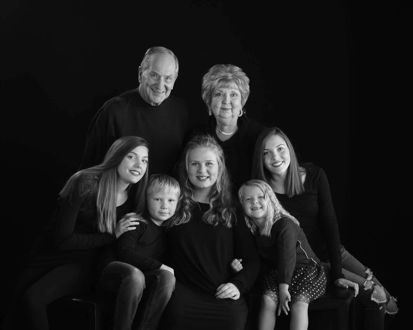 Three generations of a family, grandparents with their daughters and grandchildren, black and white portrait