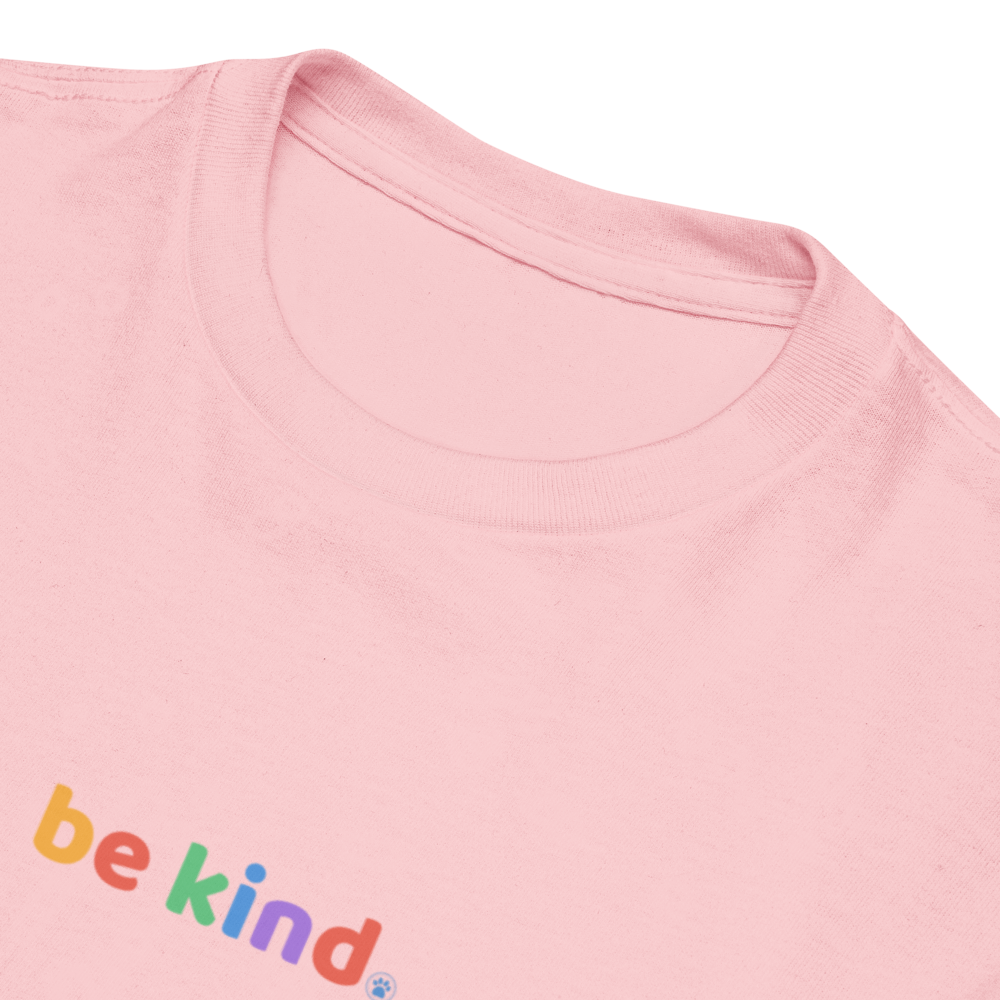 Light pink kids' t-shirt showing the rainbow be kind print on the chest