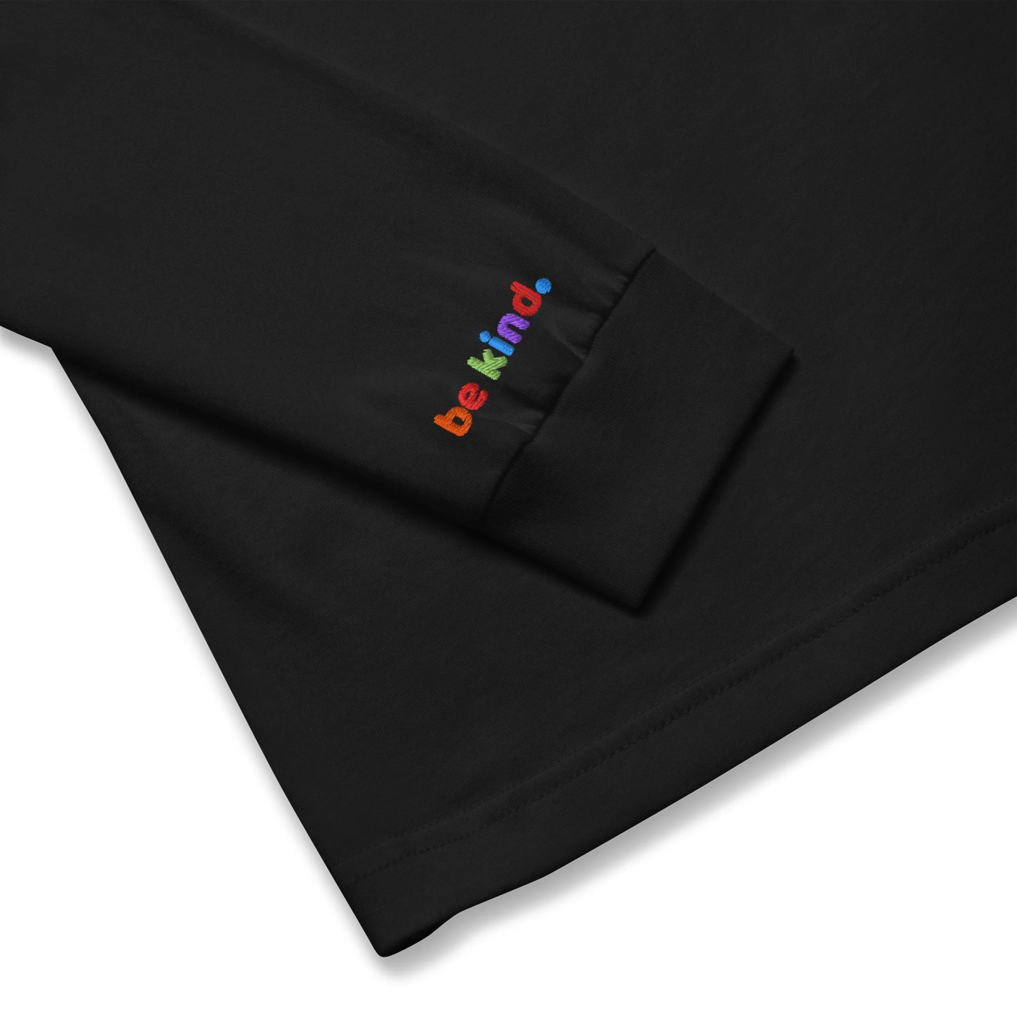 Folded black long sleeve tee with the rainbow be kind embroidered on the wrist cuff