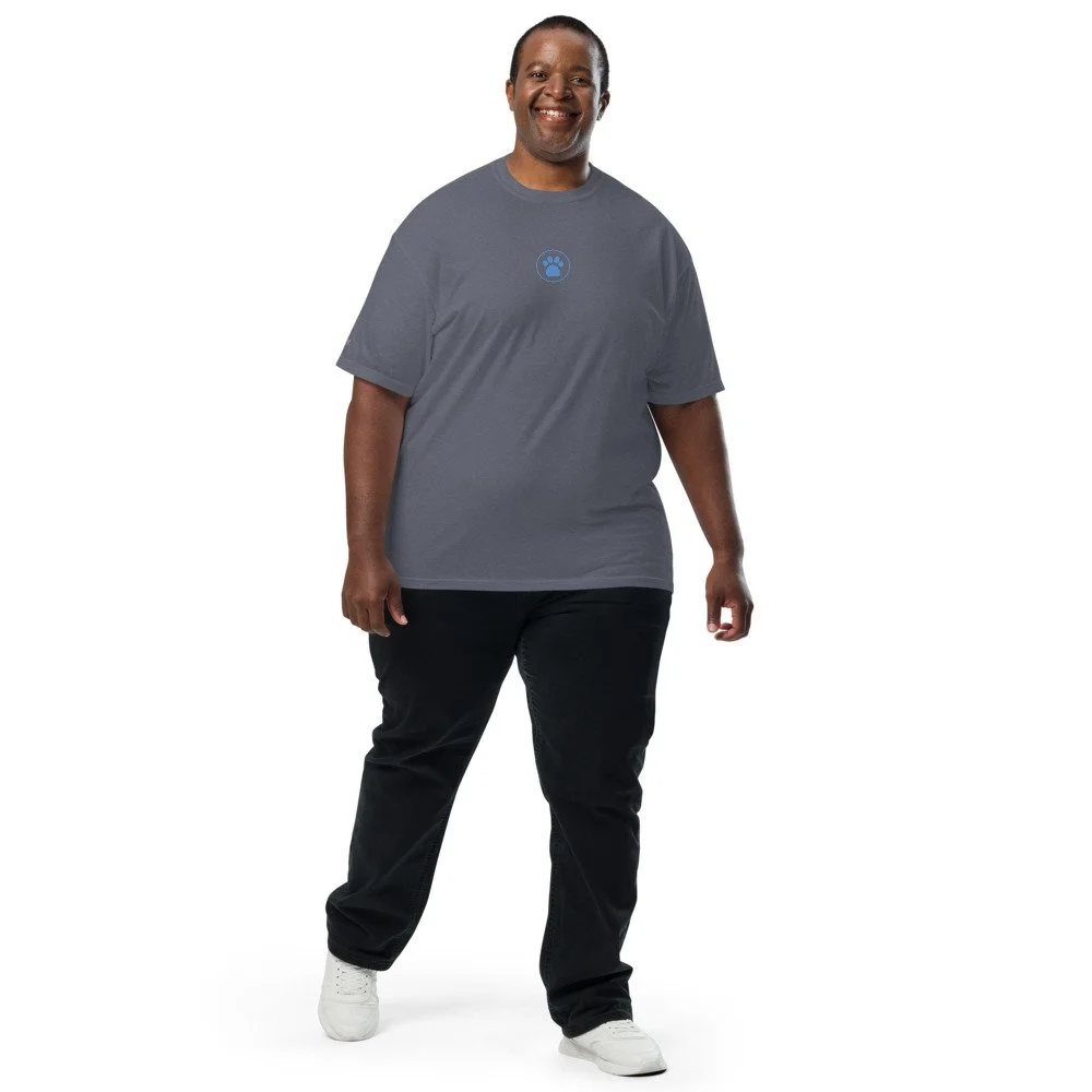 Man wearing a faded brown heavyweight tee with the blue paw print on the chest
